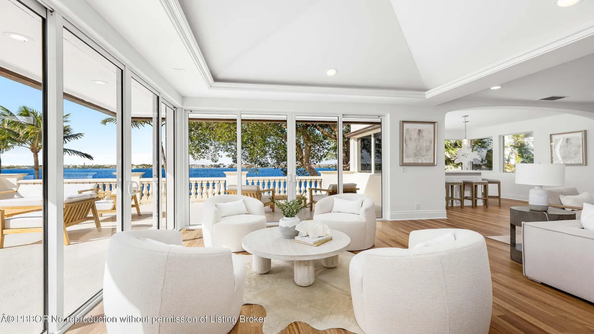 Just off this seating area, a smaller lounge space with curved chairs and a round table sits beside the windows, creating another spot to sit and take in the views across the bay.