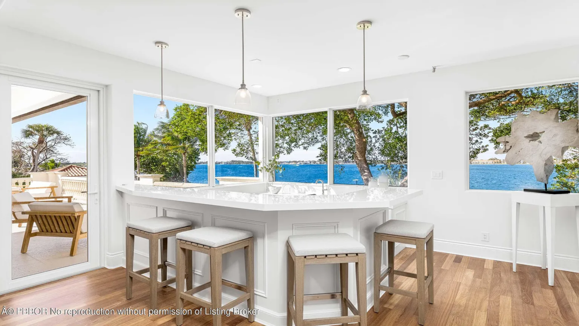 Tucked into the corner is a built-in bar finished with a white countertop and seating for several stools.