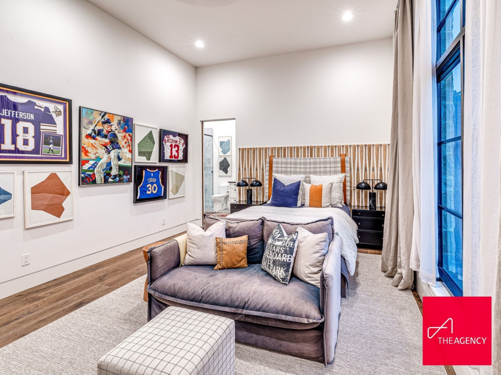 The first bedroom is lined with framed jerseys and sports artwork, creating a curated display for one of Holliday's sons looking to follow in their dad's footsteps.