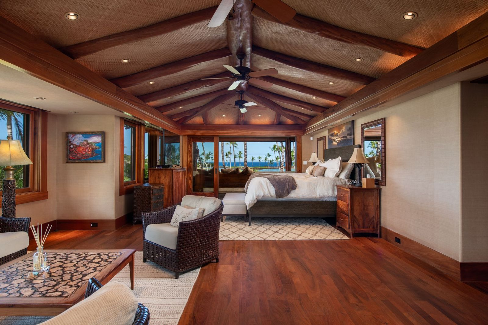 The primary suite continues the home’s use of natural materials and island-inspired design, with enough space for a sleeping area and a full lounge.