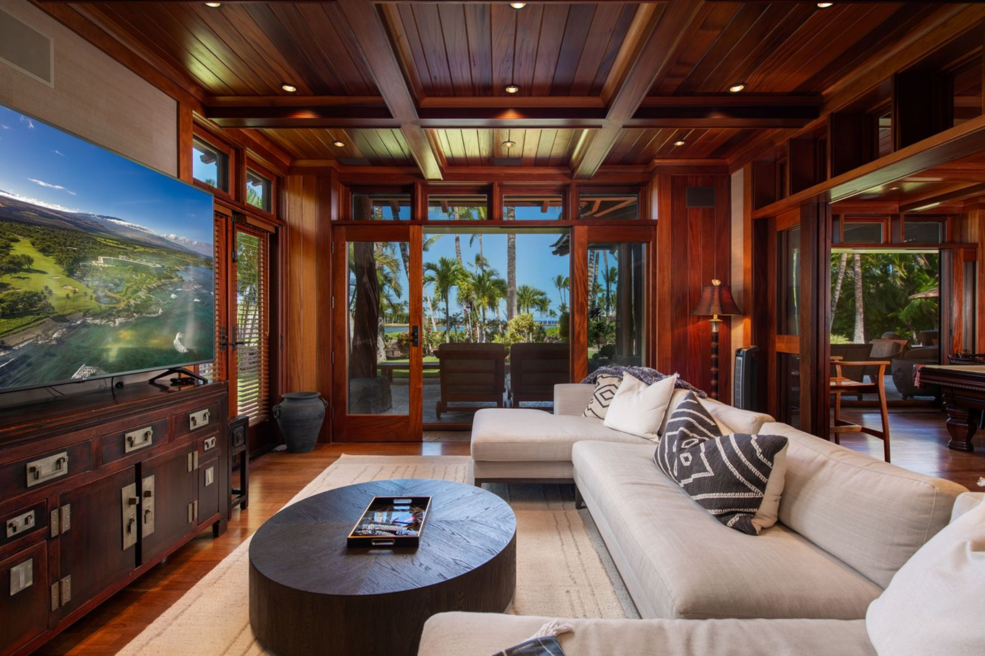 Next to the billiards room is the media room, which offers a comfortable lounge space with a large sectional sofa facing a flat-screen television.