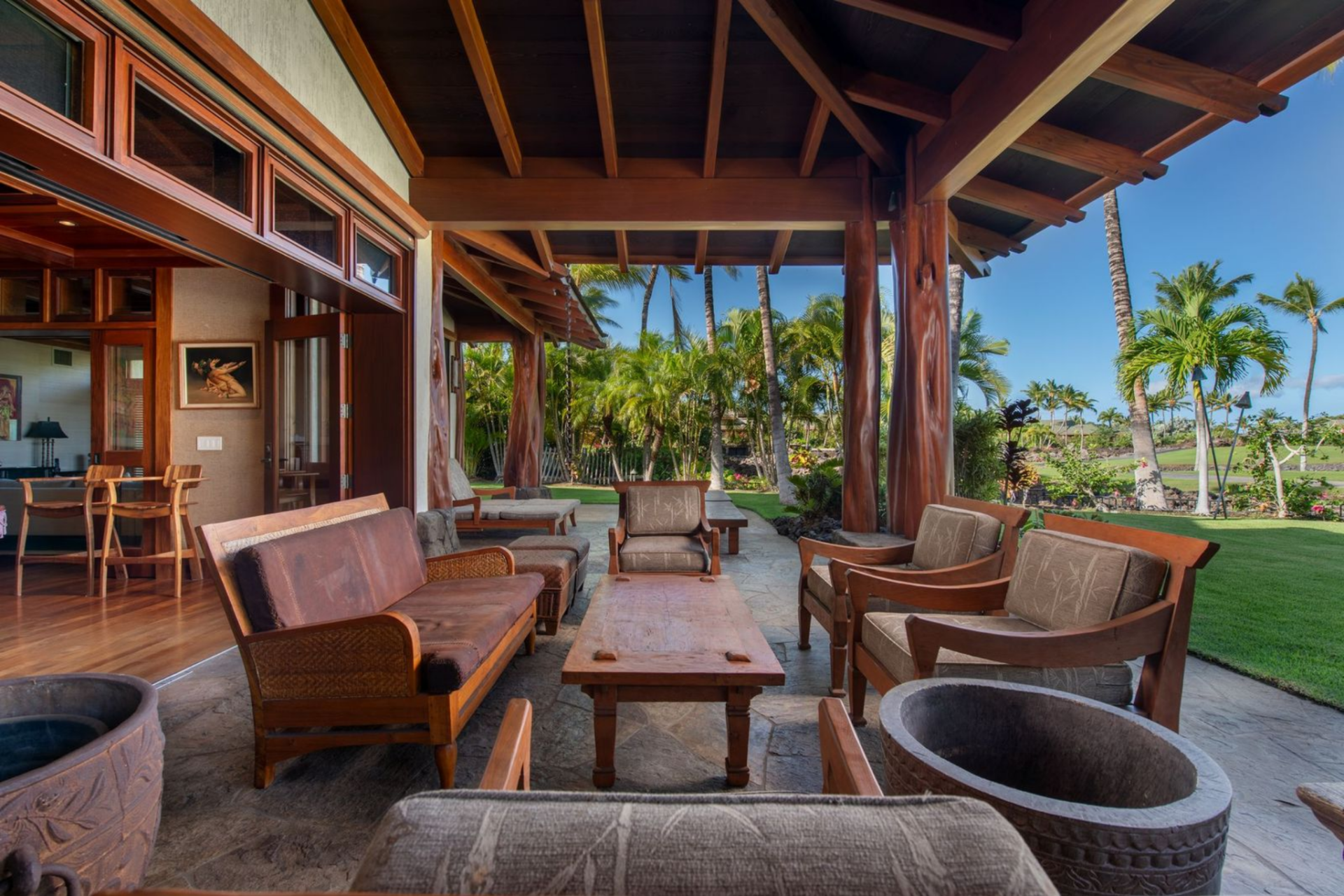 Outside, the home’s lanai extends the living spaces into a series of covered outdoor lounges designed for relaxing and entertaining. 