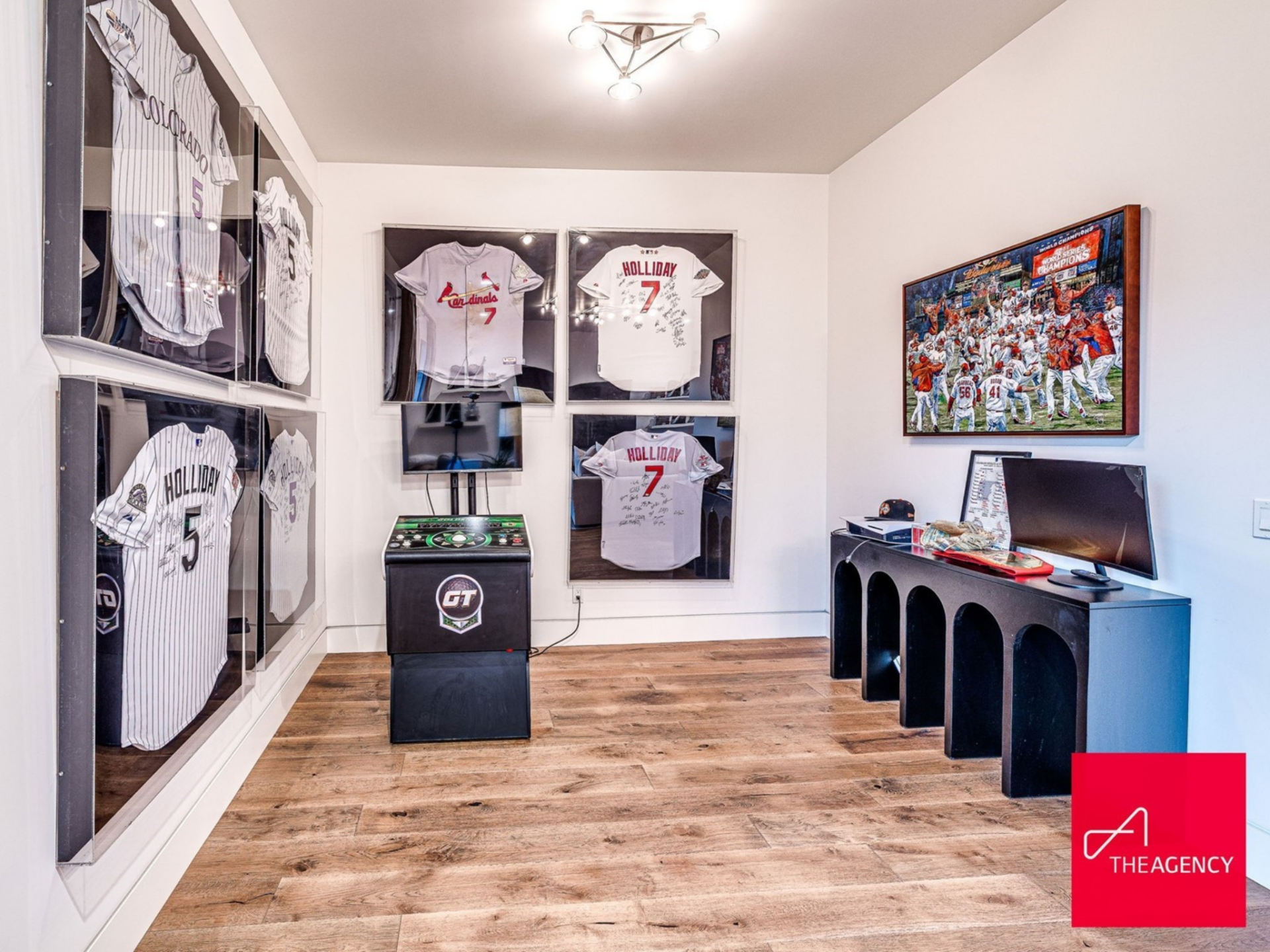 Expansive windows overlook the grounds, while walls showcase framed jerseys and signed pieces from Holliday’s career, turning the room into both a family hangout and a personal gallery.