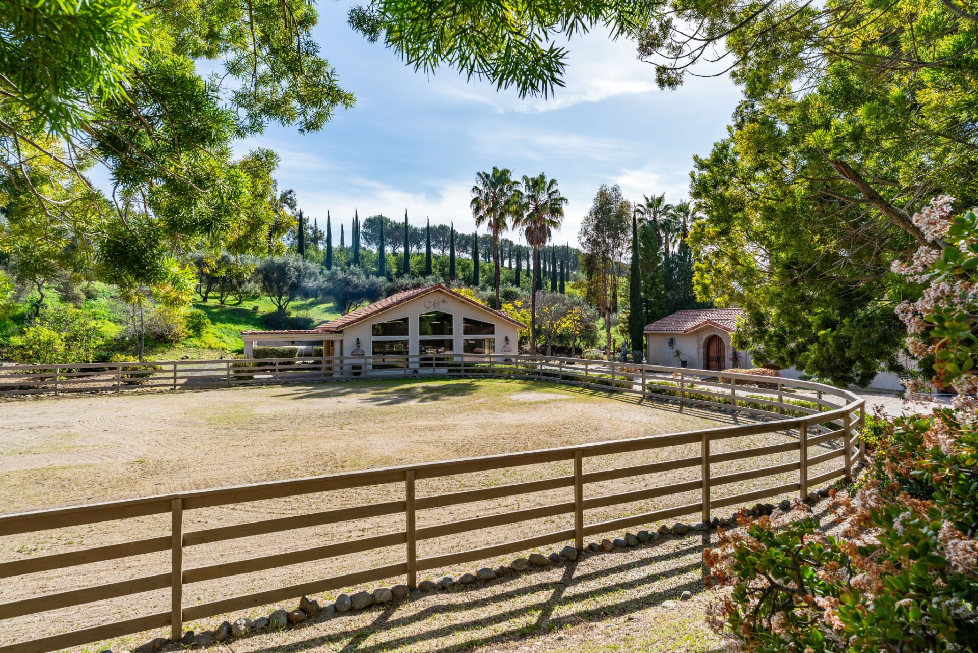Recreation continues with an equestrian area that includes a circular riding ring positioned near the studio. 