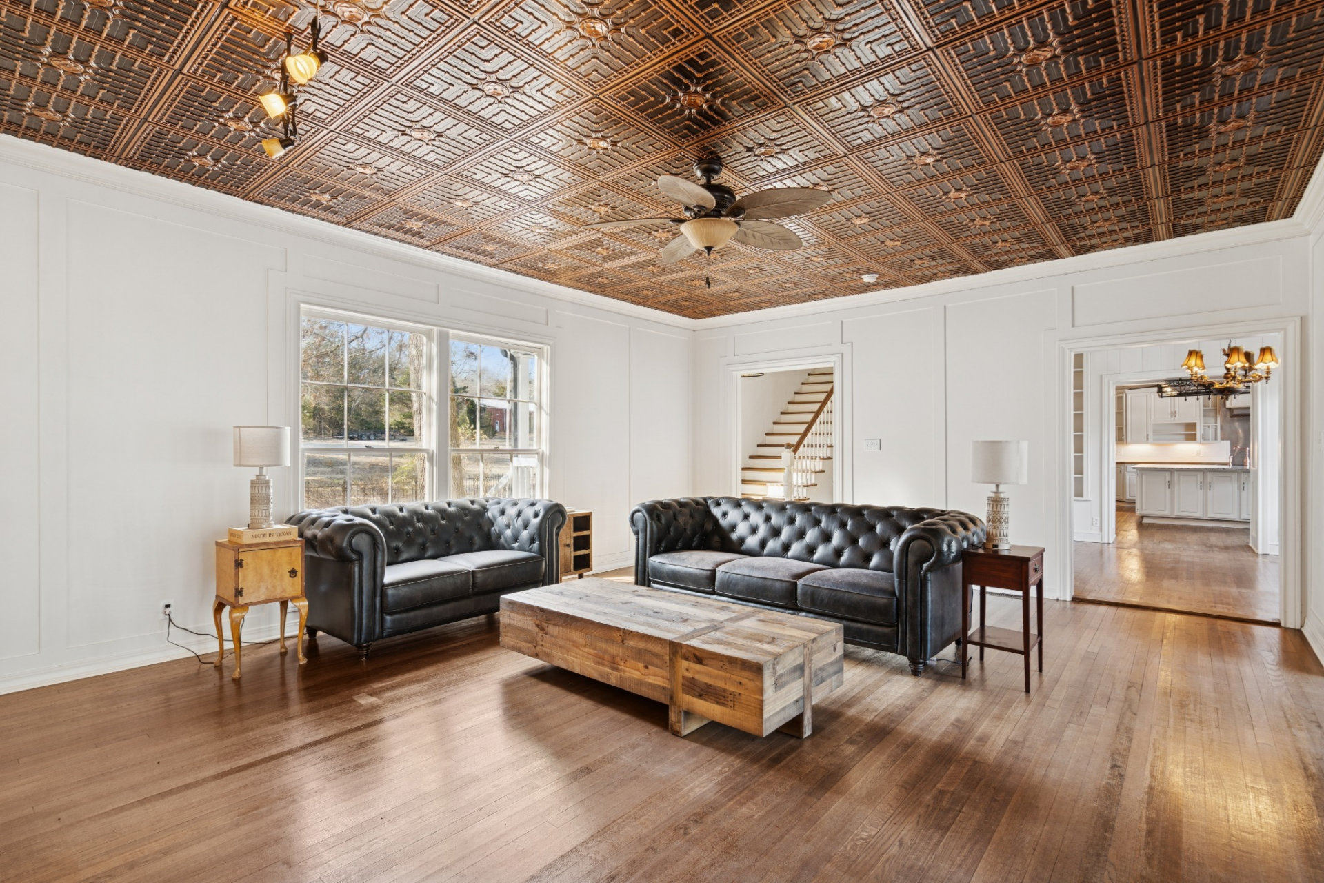 White paneled walls keep the space clean and simple, while large windows bring in natural light from the front of the property.