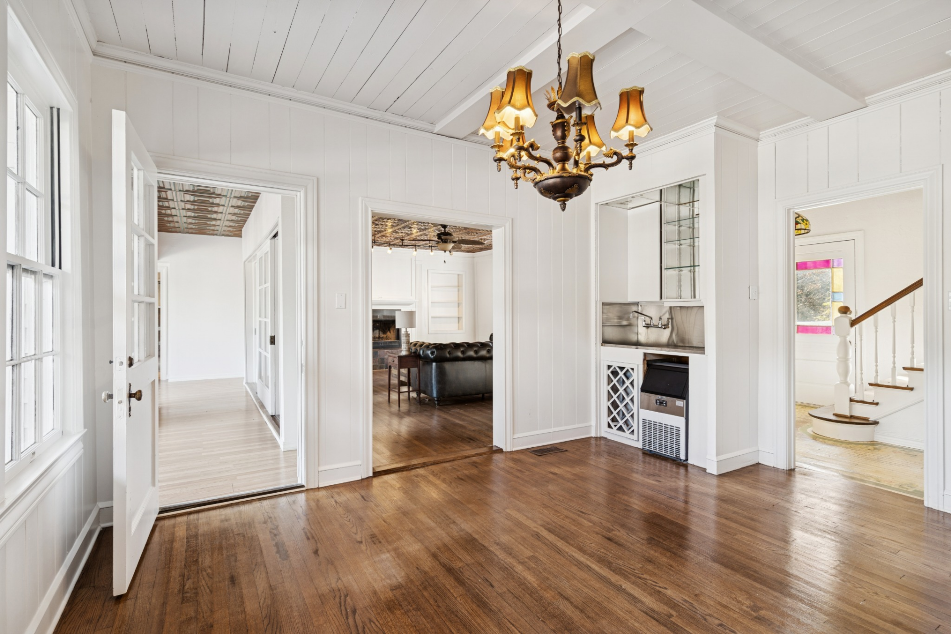 At the center of the first level, the dining room acts as a connecting hub, with doorways leading out to multiple areas of the home.