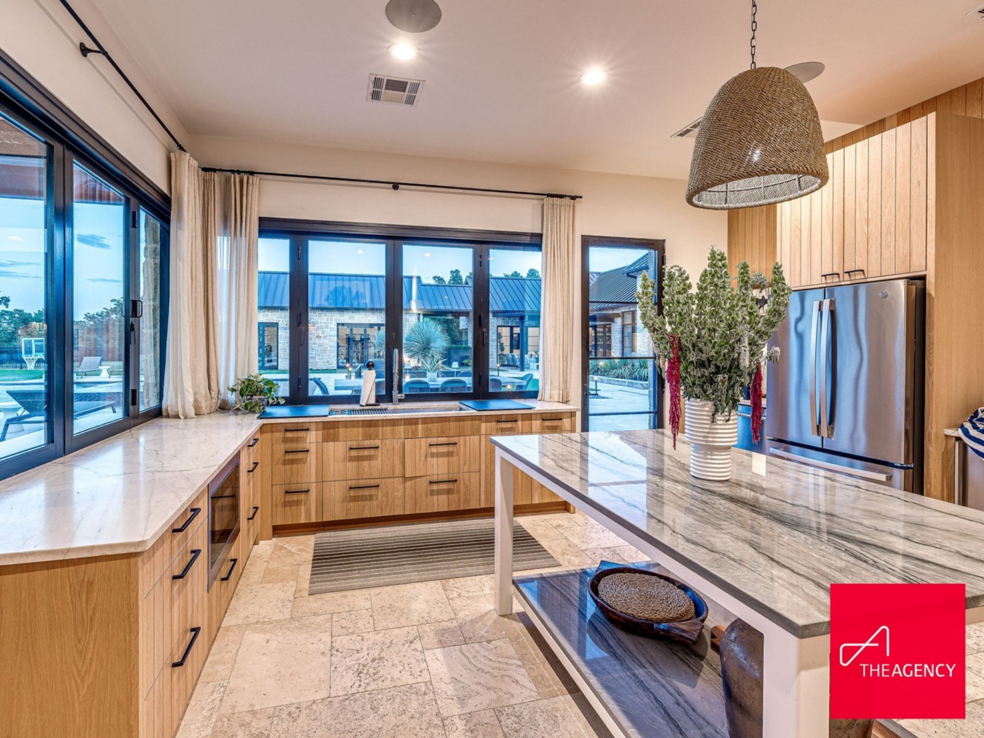Positioned just off the pool area, it connects directly to the patio through large windows and doors, making it ideal for hosting and casual family dinners outside.