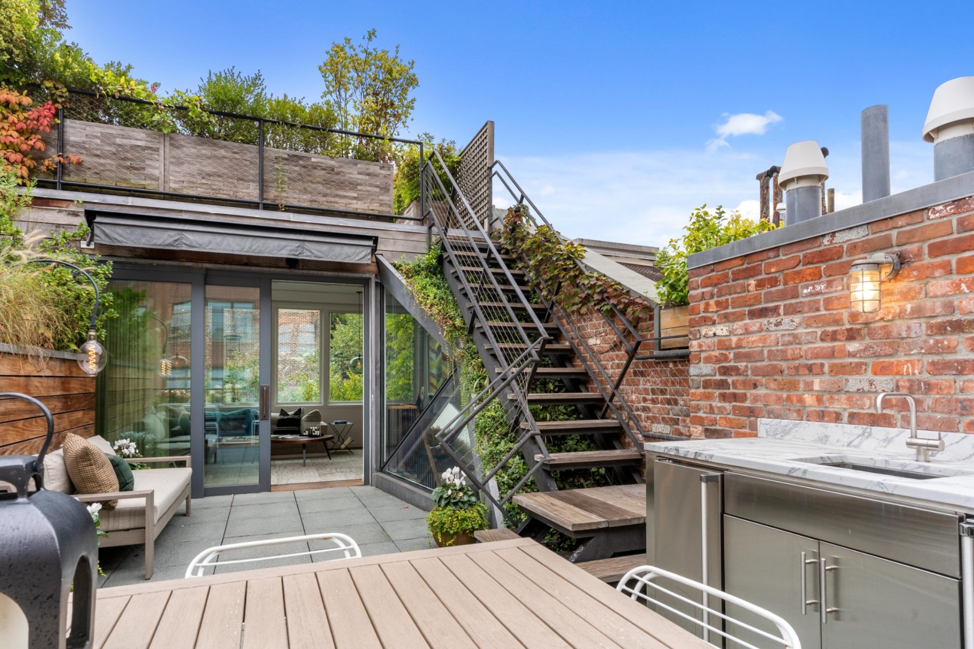 Higher up, the fifth-floor terrace is designed for more active entertaining, centered around an outdoor kitchen and built-in wet bar.