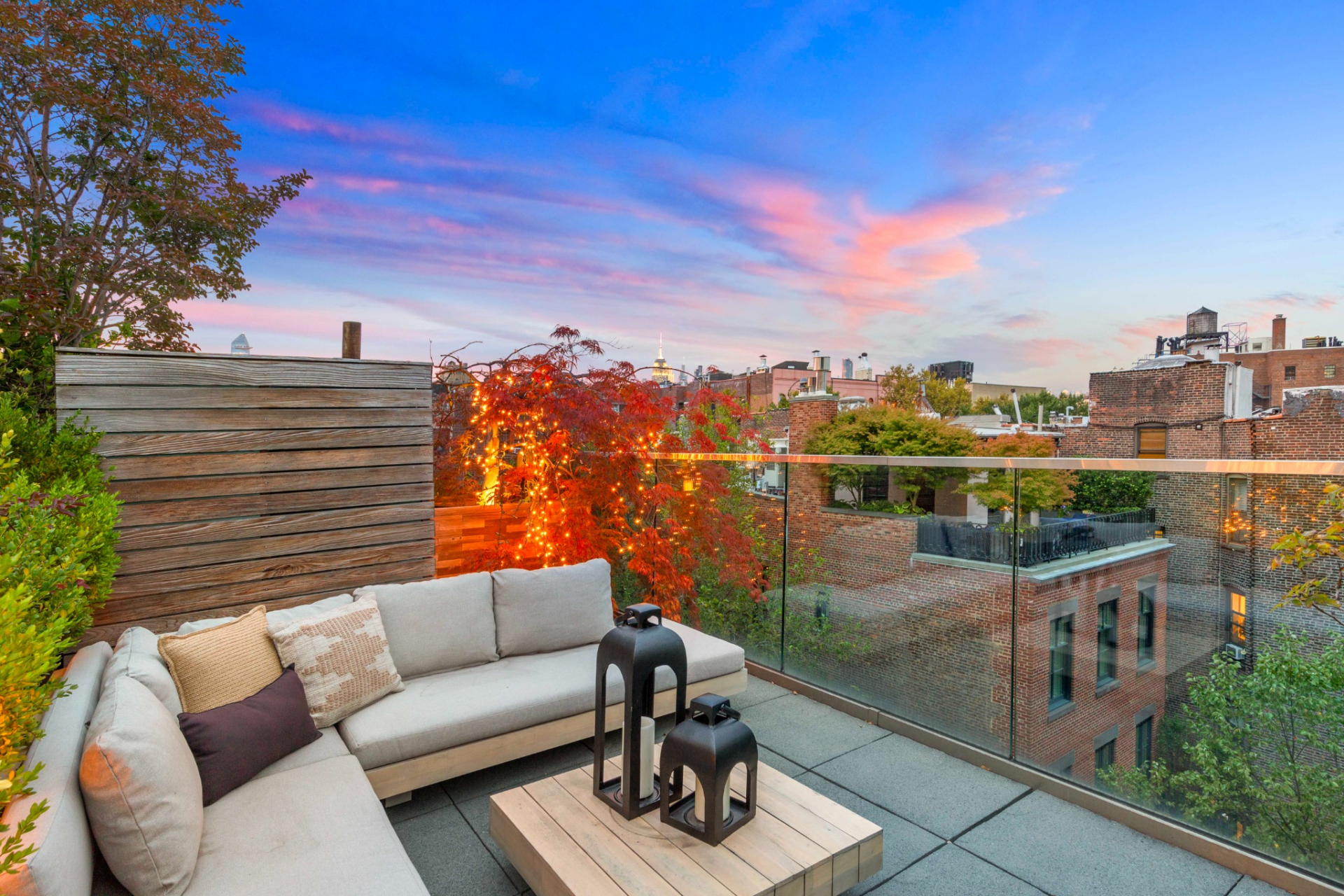 At the top, the rooftop deck opens up to wide views over the surrounding cityscape, including sightlines toward landmarks like the Empire State Building and One World Trade Center.