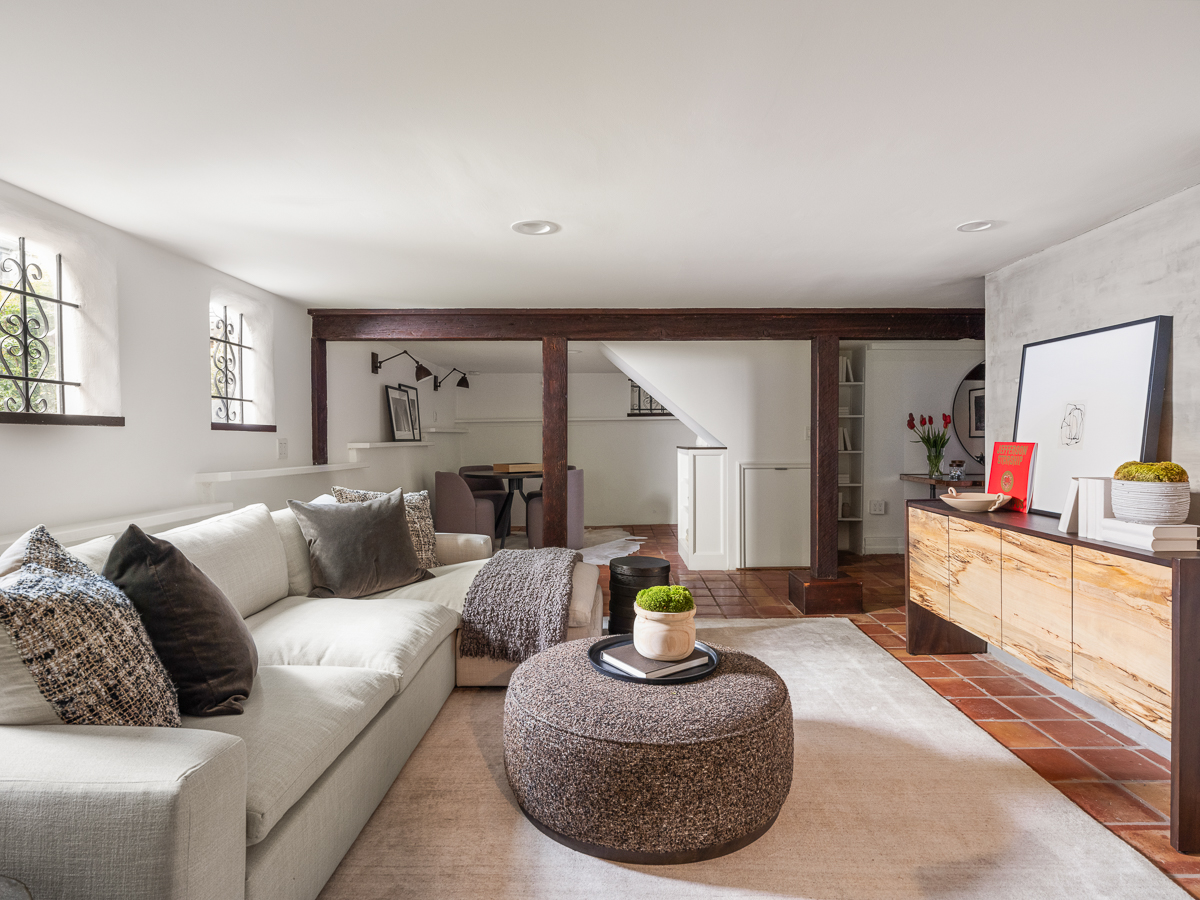 Above the garage, a carriage house is configured as a separate one-bedroom apartment, offering a fully independent living space. 