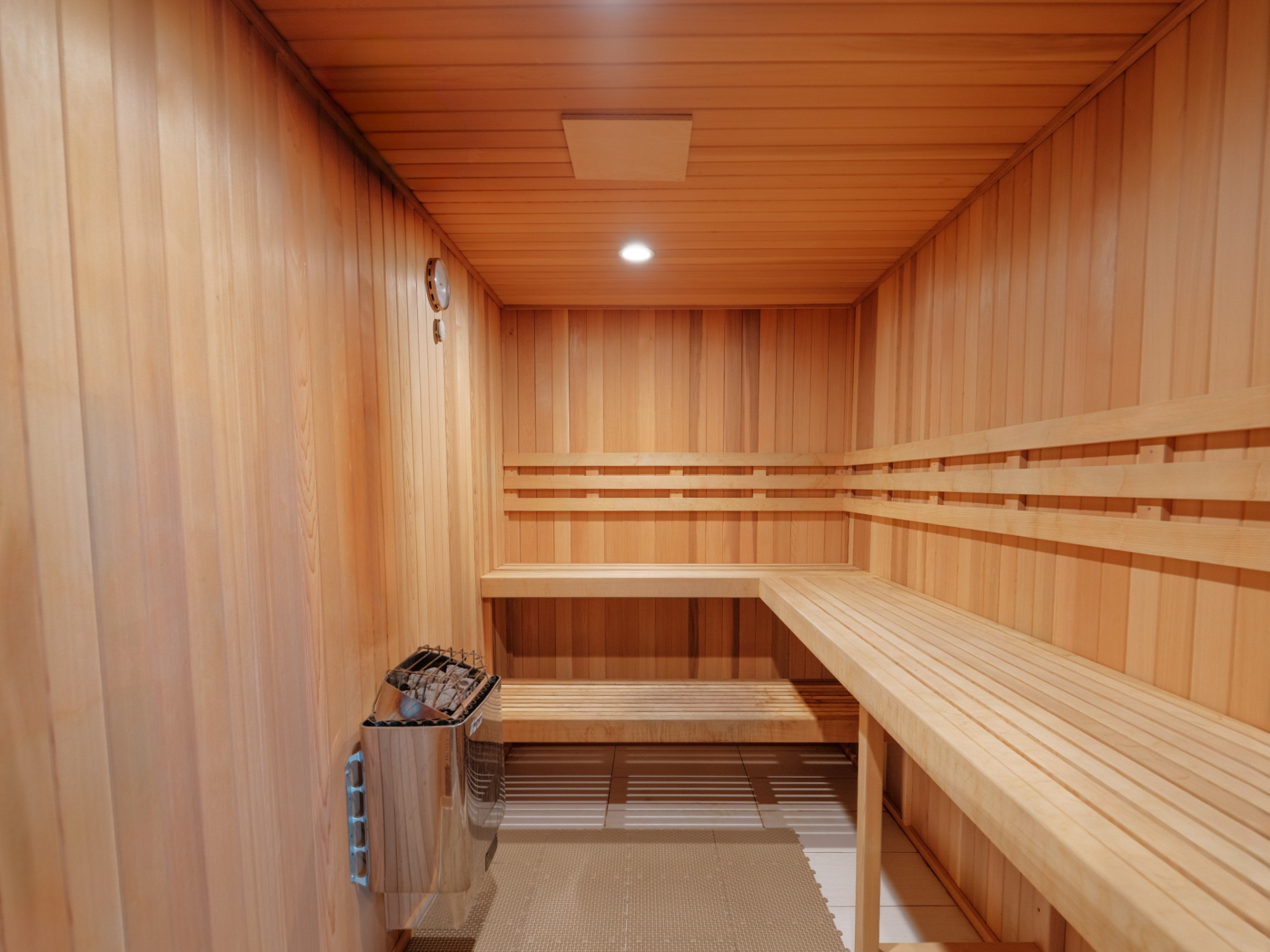 Rounding out the amenities is a dedicated sauna, fully wrapped in warm wood from floor to ceiling. 