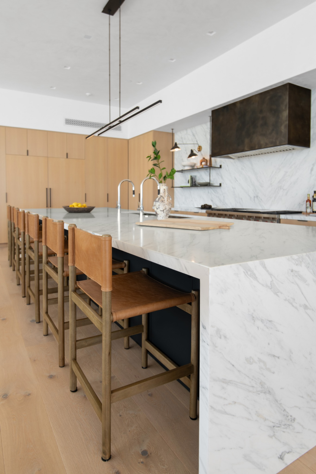 Behind the living room, the kitchen centers around an 18-foot marble island that stretches through the space.