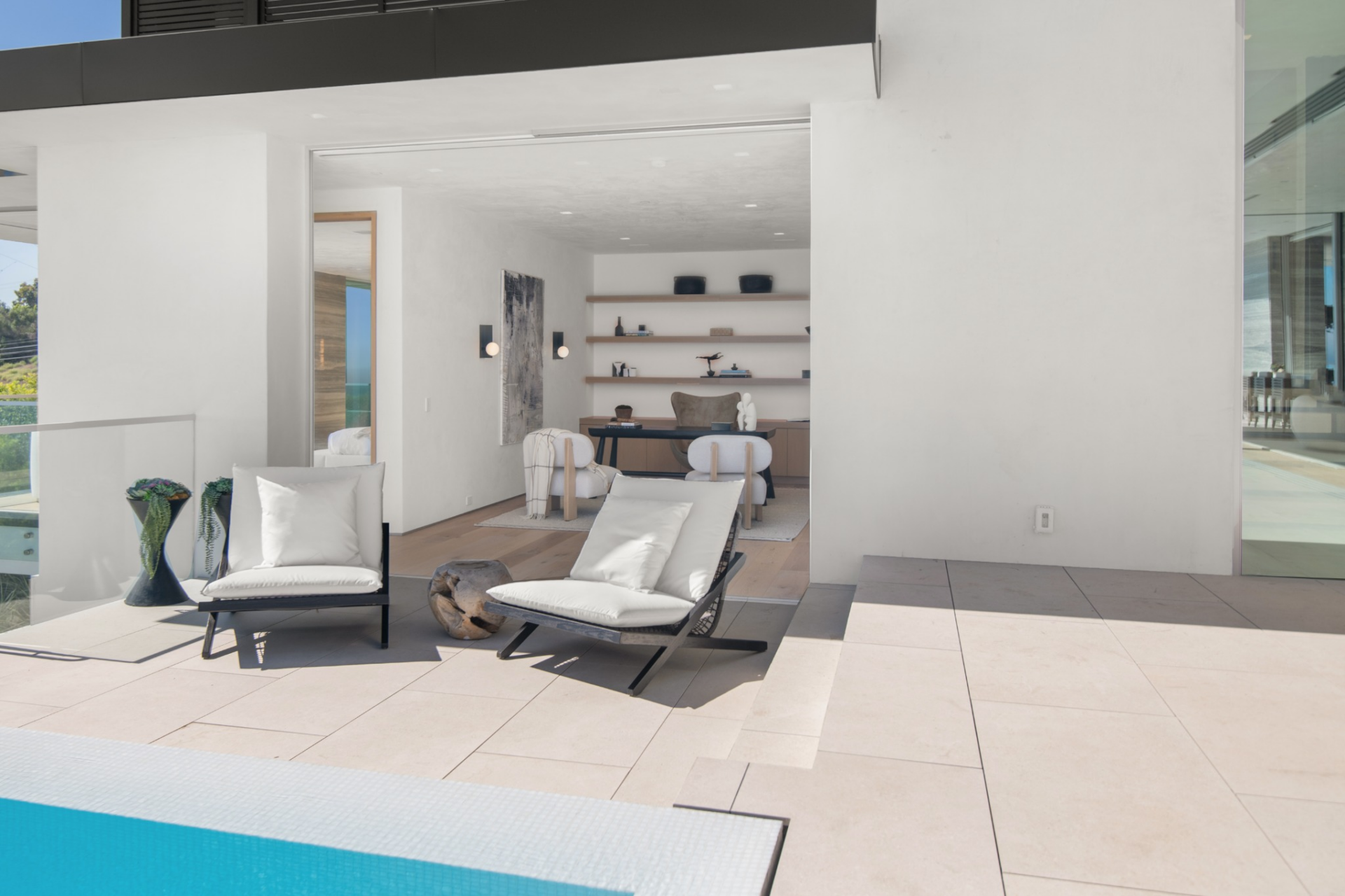 Connected to the primary suite is a private office or studio that opens directly to the terrace through a wide sliding glass door.
