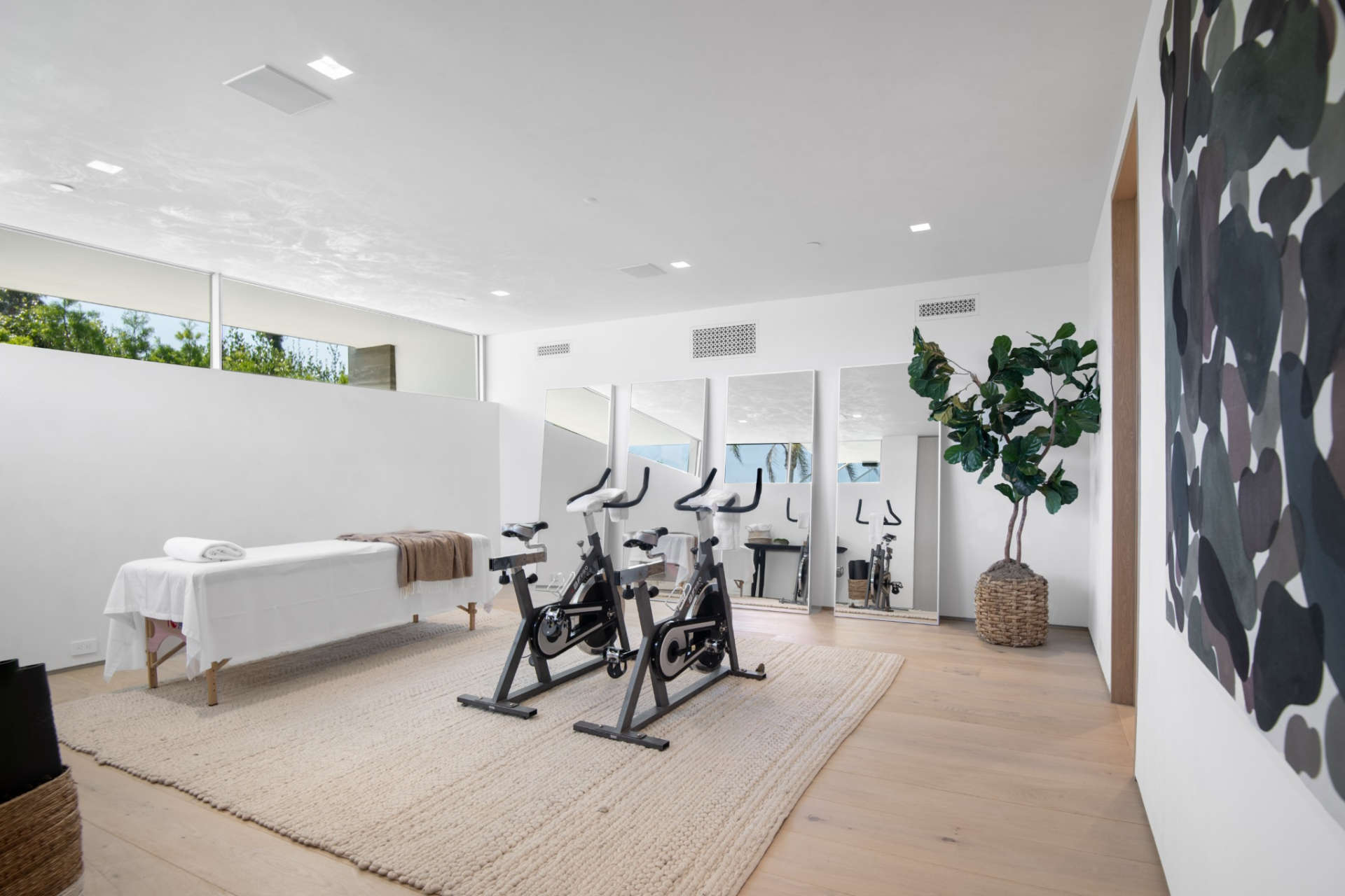 Also among the home’s interior amenities is a dedicated fitness room where full-length mirrors and high clerestory-style windows keep the room bright.