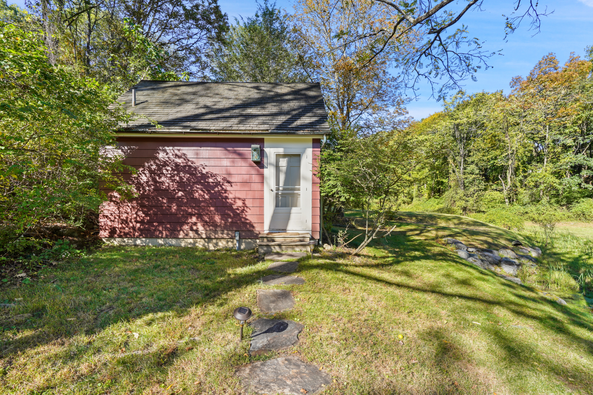A stone path leads you towards the guest cottage, which sits a little farther from the main house, tucked within the trees.