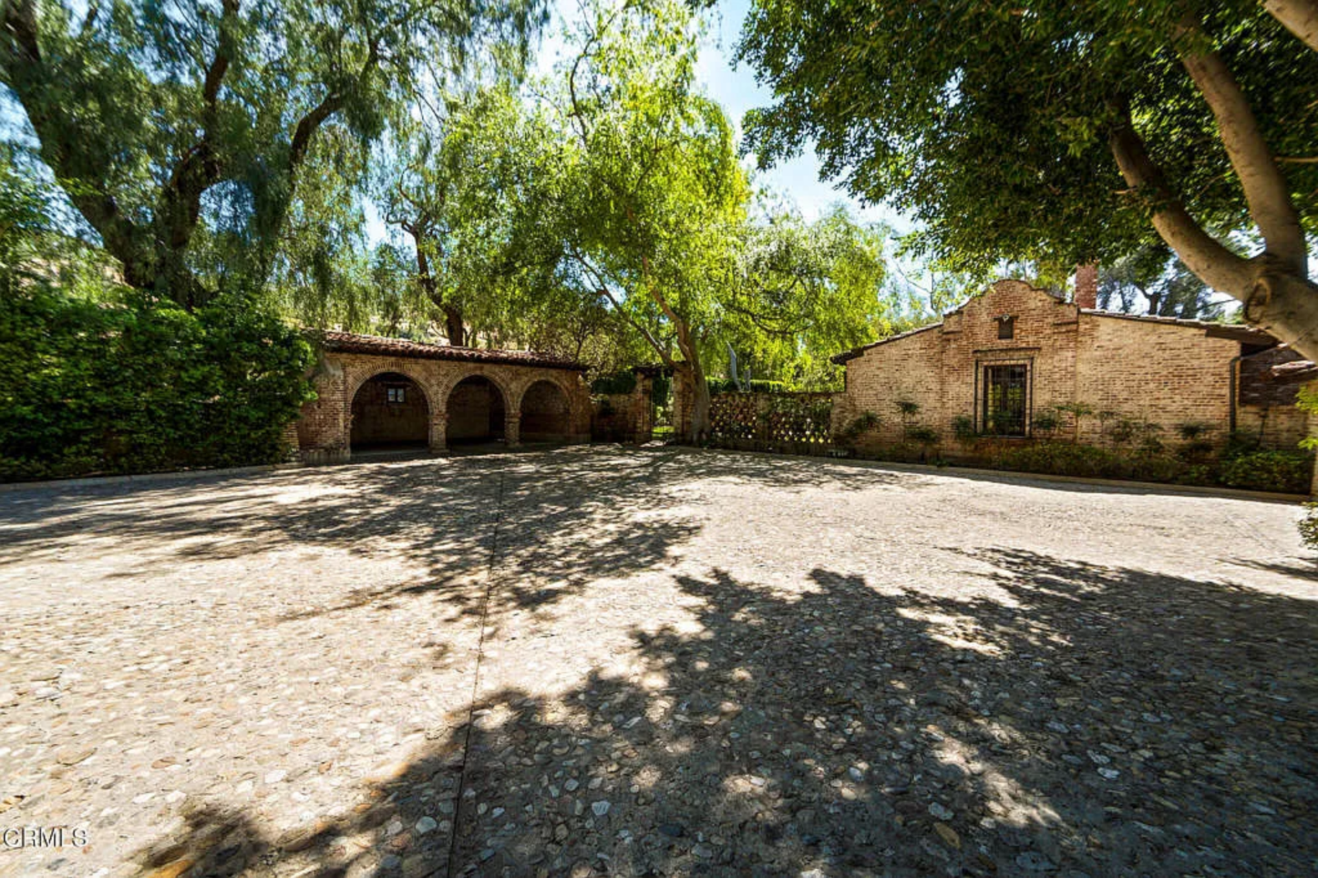 One of the guest villas is arranged more like a separate house, with its own courtyard approach, full kitchen, dining room, and private pool area set away from the main villa.