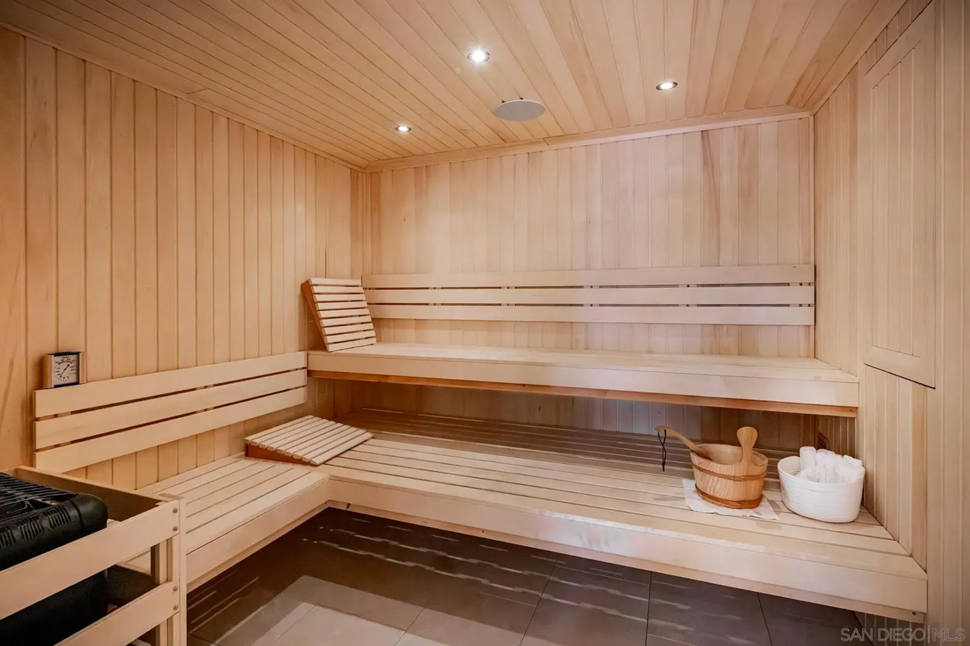 Completing the setup is a dedicated sauna finished in light wood, with wraparound bench seating and enough space for two.