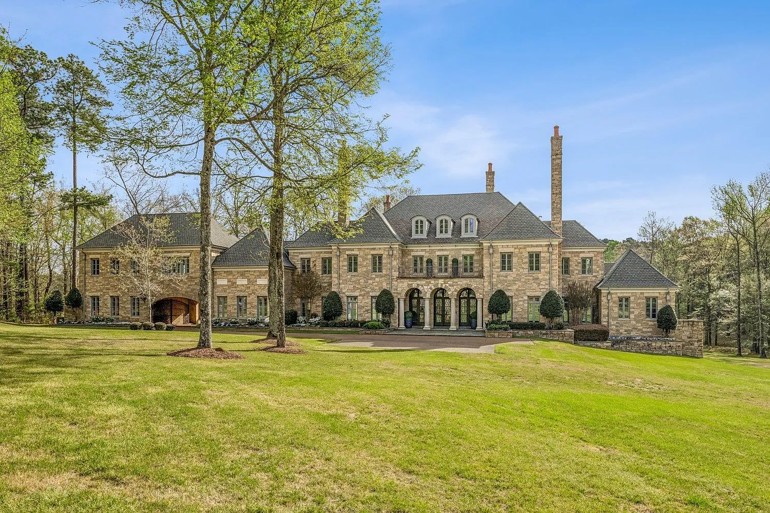 The brick castle-like exterior of Ja Morant's Eads mansion past a long green lawn.