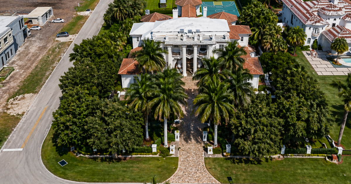 A circular driveway laid out around a center fountain leads to the main home of Hill's mansion.
