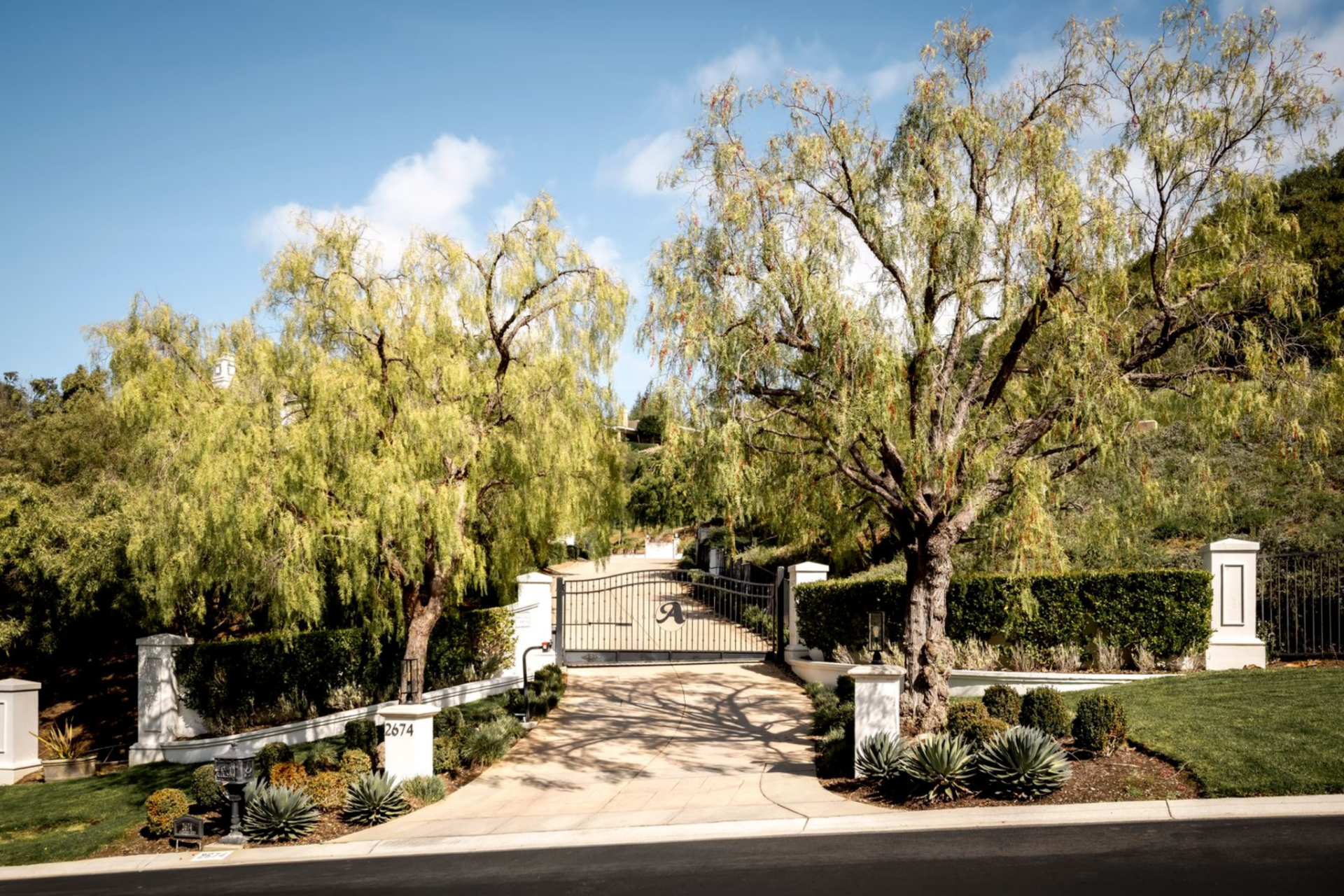 Set on more than five acres within the gates of Sherwood Country Club, the entrance to Paul Anka's Westlake Village Mansion begins at a wrought-iron entry gate framed by tall trees and clipped hedges. 