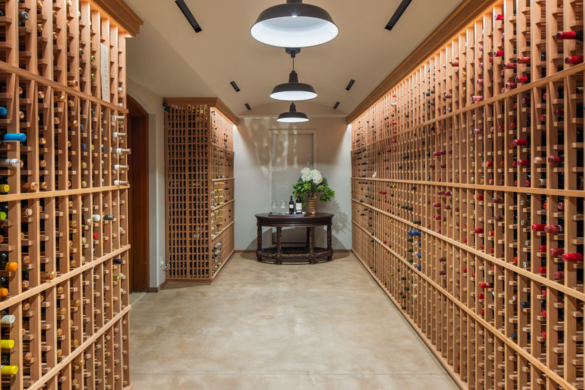 The wine cellar shifts again into a long room where bottle storage runs in uninterrupted rows from floor to near ceiling on both sides.