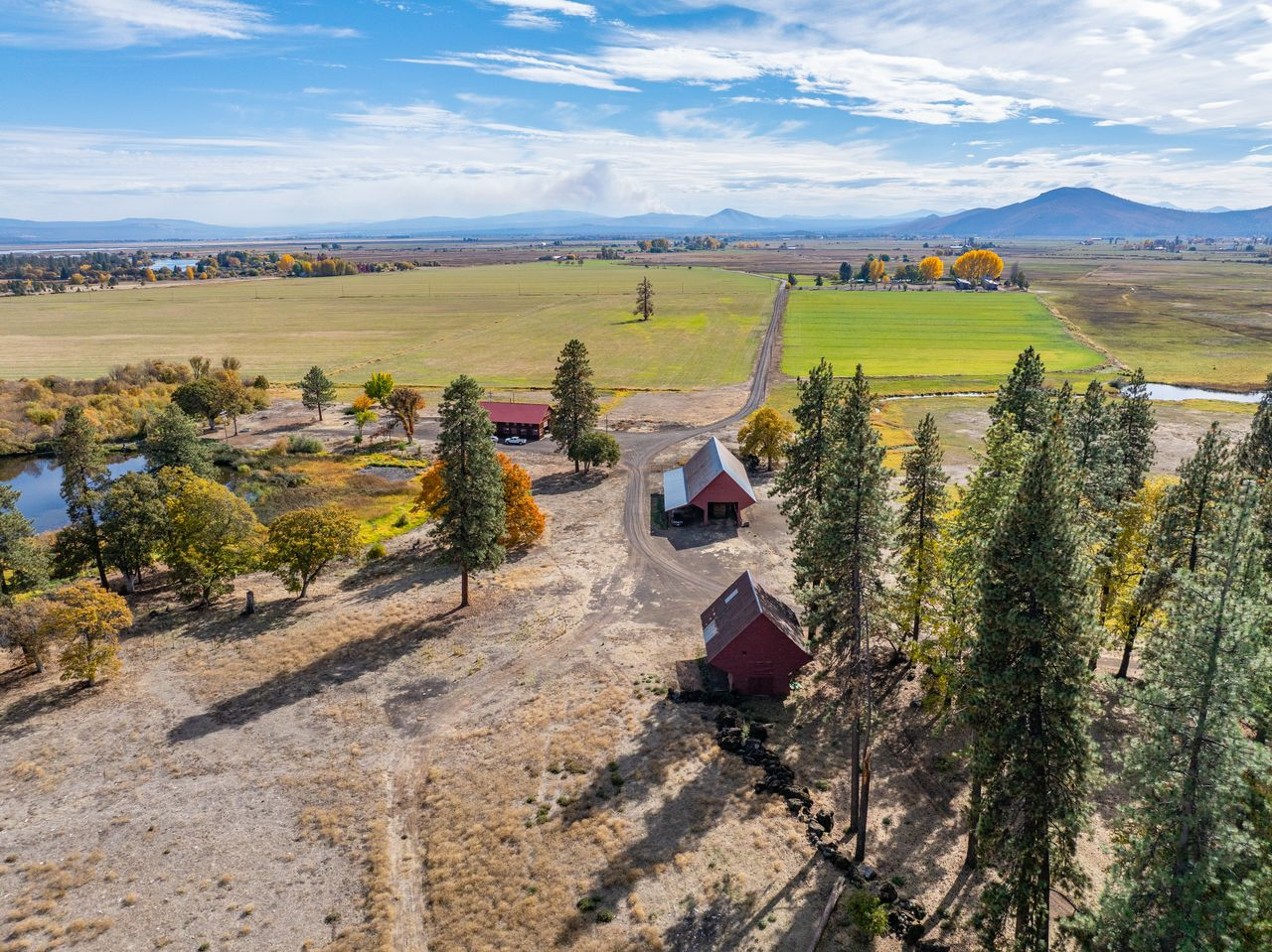 The land is divided across multiple parcels and zoning designations, combining agricultural use with natural habitat. 