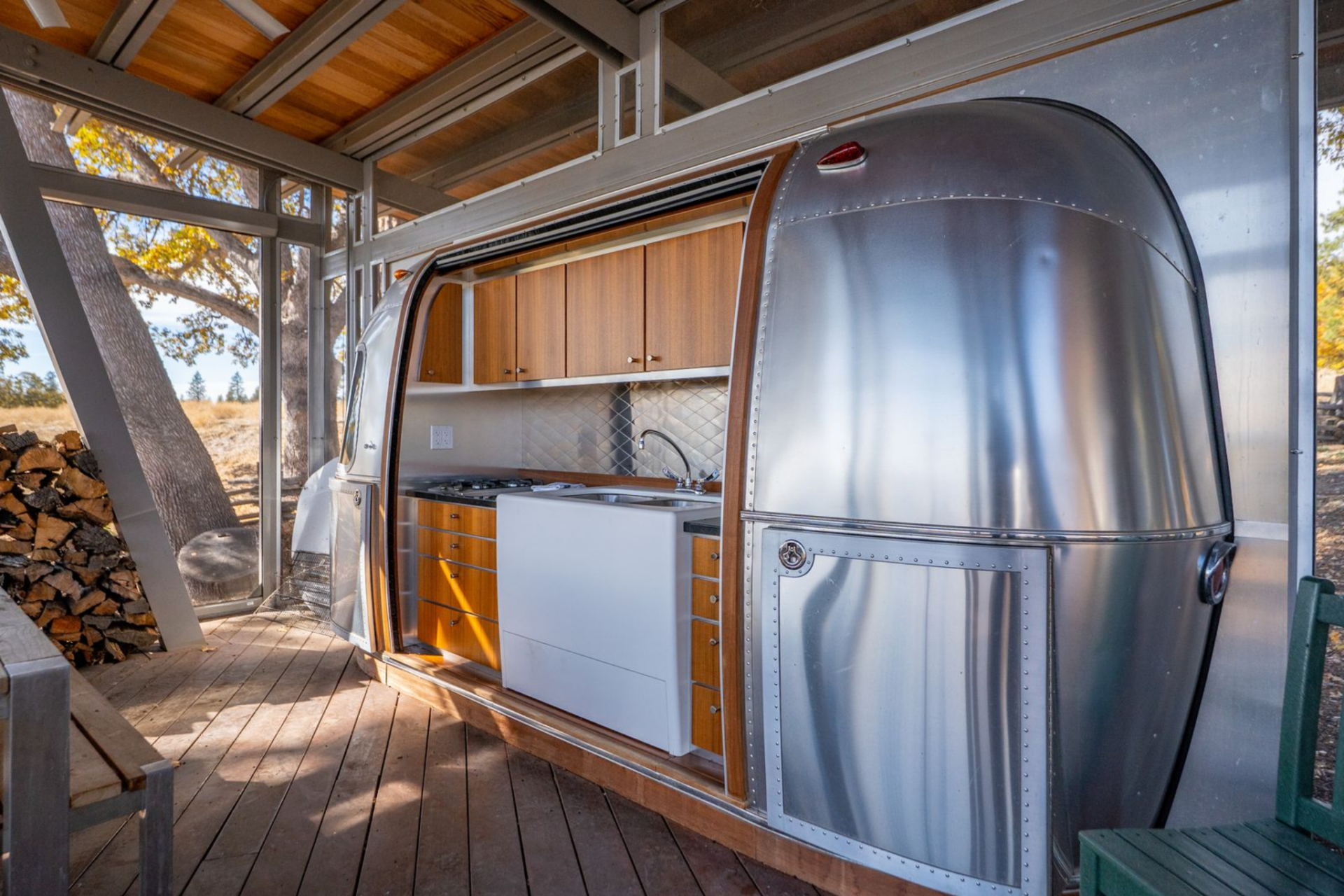 At the center of the Airstream camp, the shared kitchen area is built around a screened pavilion that works as both a gathering space and a service hub for the trailers around it. 