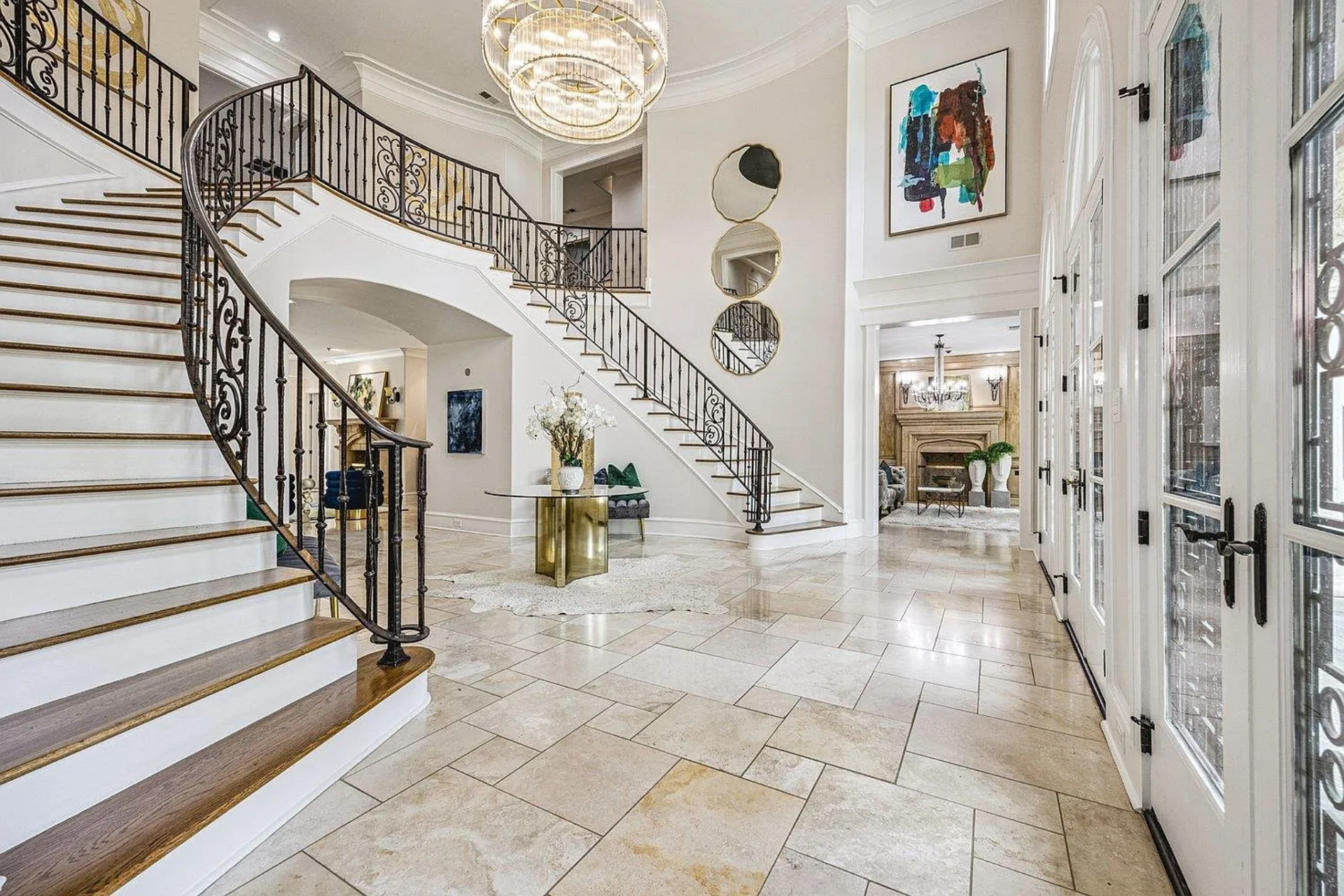 The railings are finished in dark wrought iron with decorative detailing, contrasting against the lighter tones of the walls and stair risers.