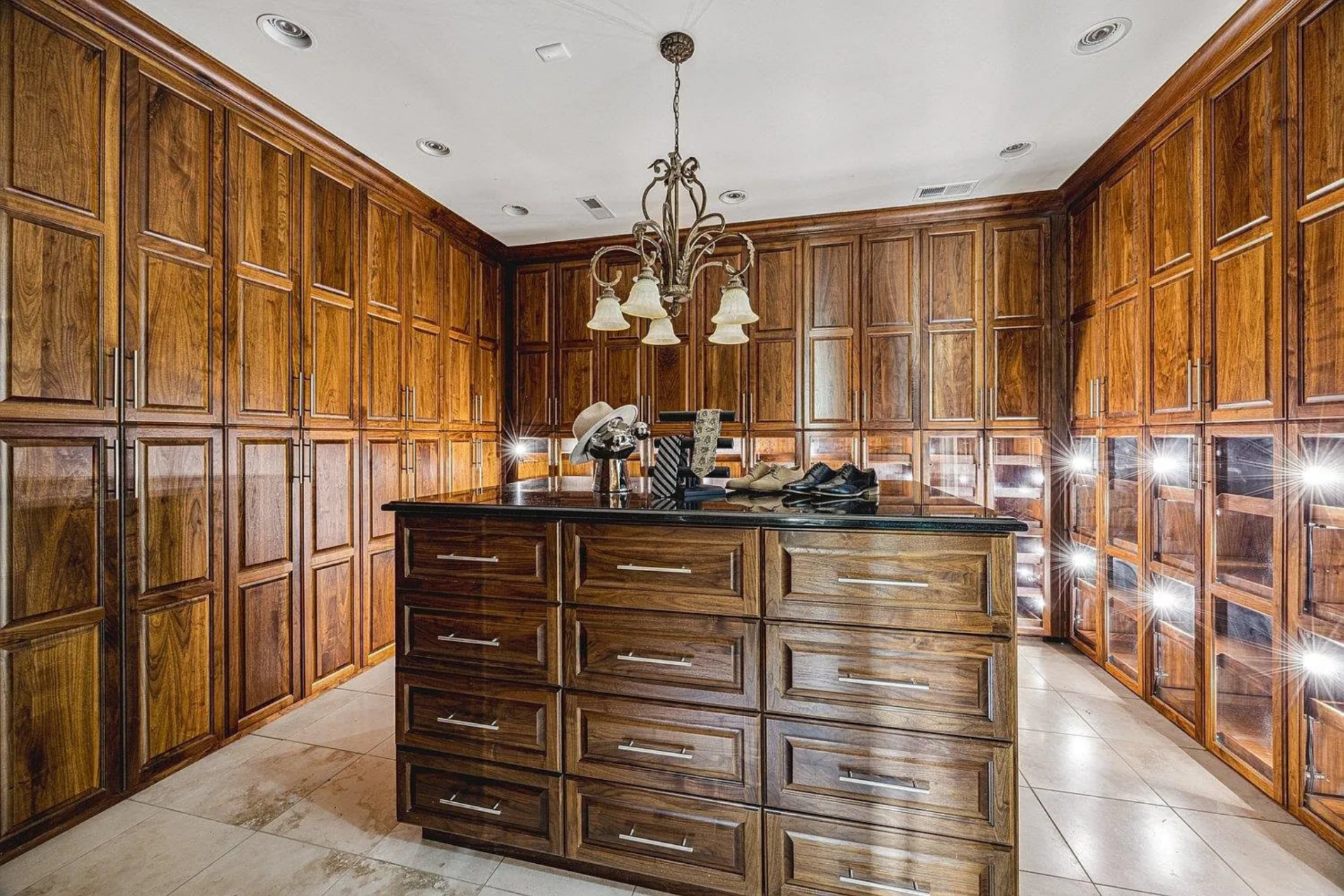 Finishing the suite is a closet fully lined with floor-to-ceiling wood cabinetry wrapping all sides of the room.