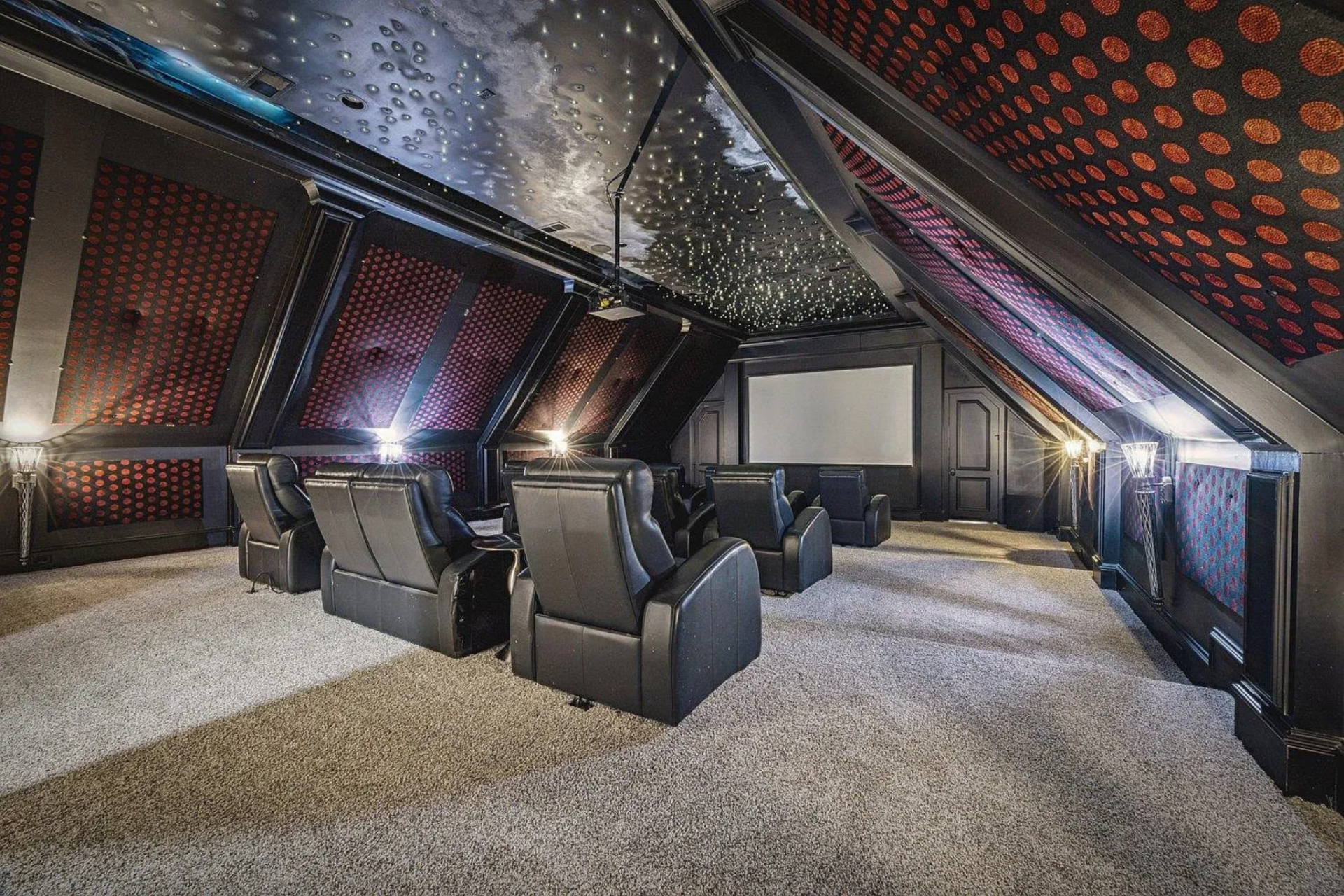 A custom home theater delivers a true cinematic experience, with tiered leather seating facing a large projection screen.
