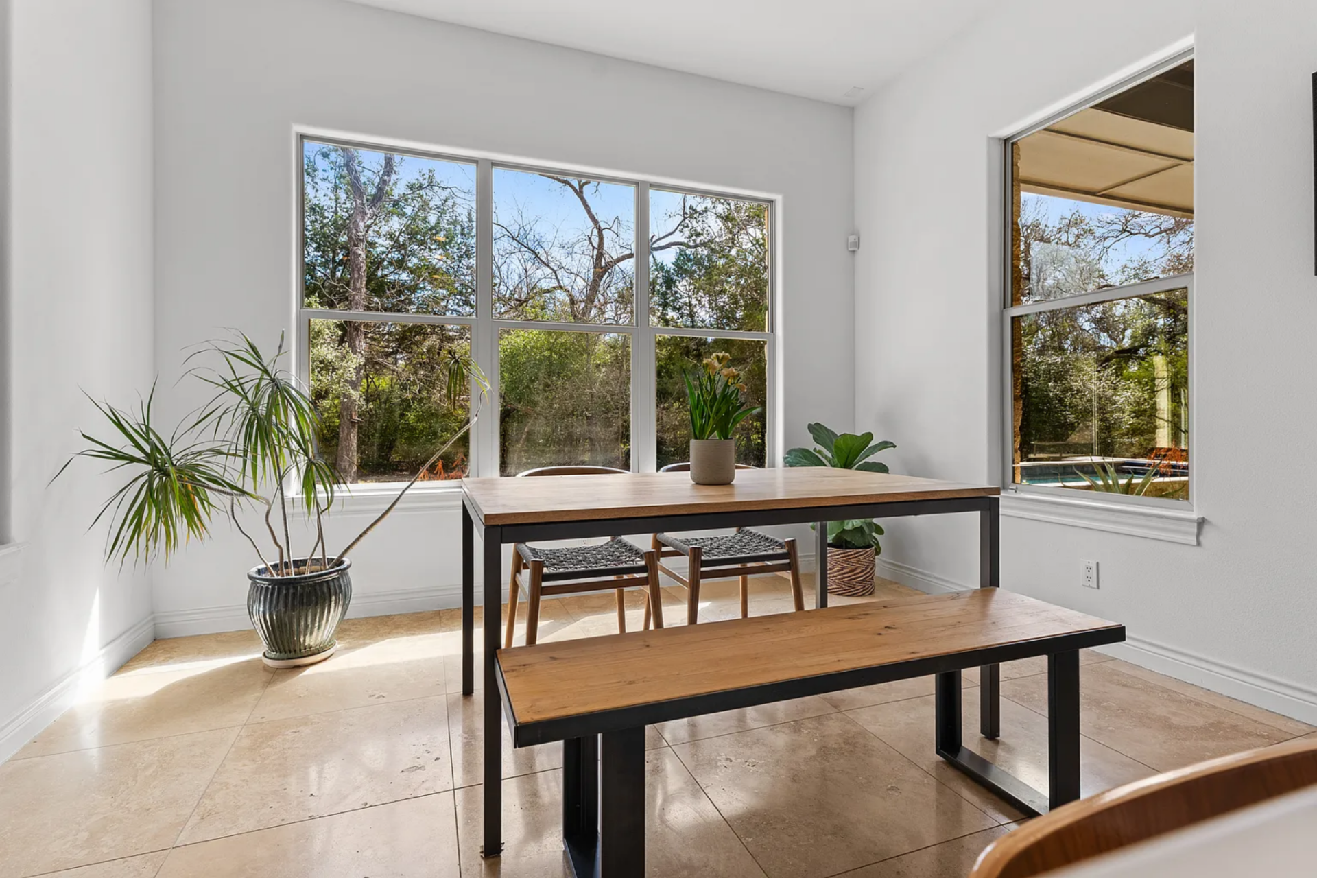 Nearby, the breakfast alcove creates a more casual place to eat with a simple wood table and a matching bench.