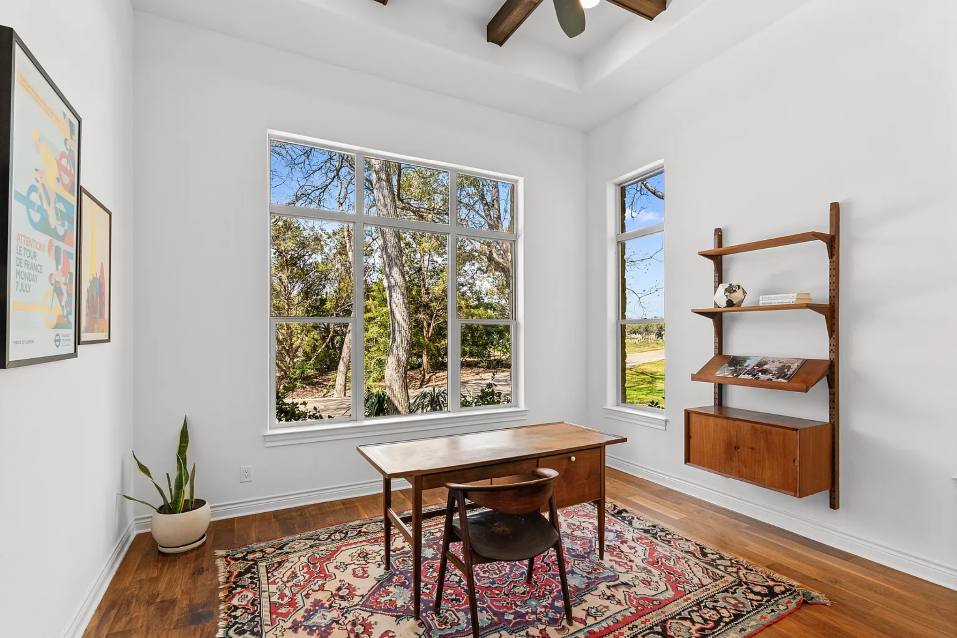 Just off the bedroom, a separate office consists of a simple wood desk placed directly in front of oversized windows, making the outdoor greenery the focal point while working. 