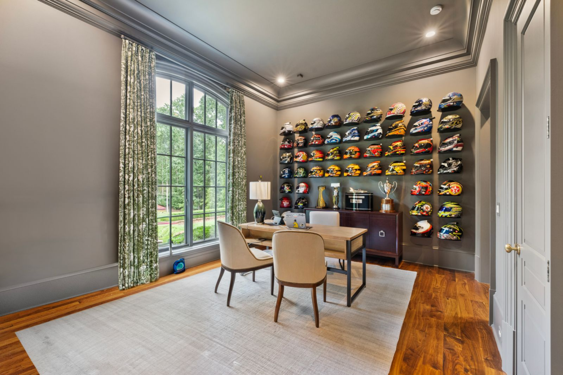McMurray’s office is set up as both a workspace and a personal display room, with one entire wall turned into a gallery of racing helmets and trophies.