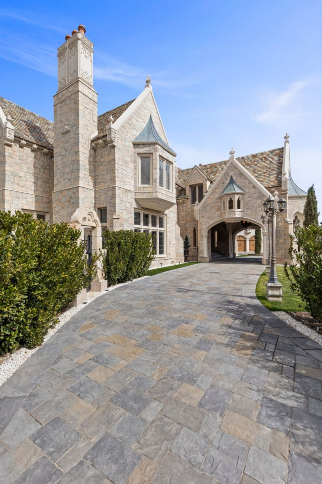 As you move forward, the 17th-century European exterior reveals itself in layers, with light-colored stone, steeply pitched rooflines, and carved detailing around the windows and gables.