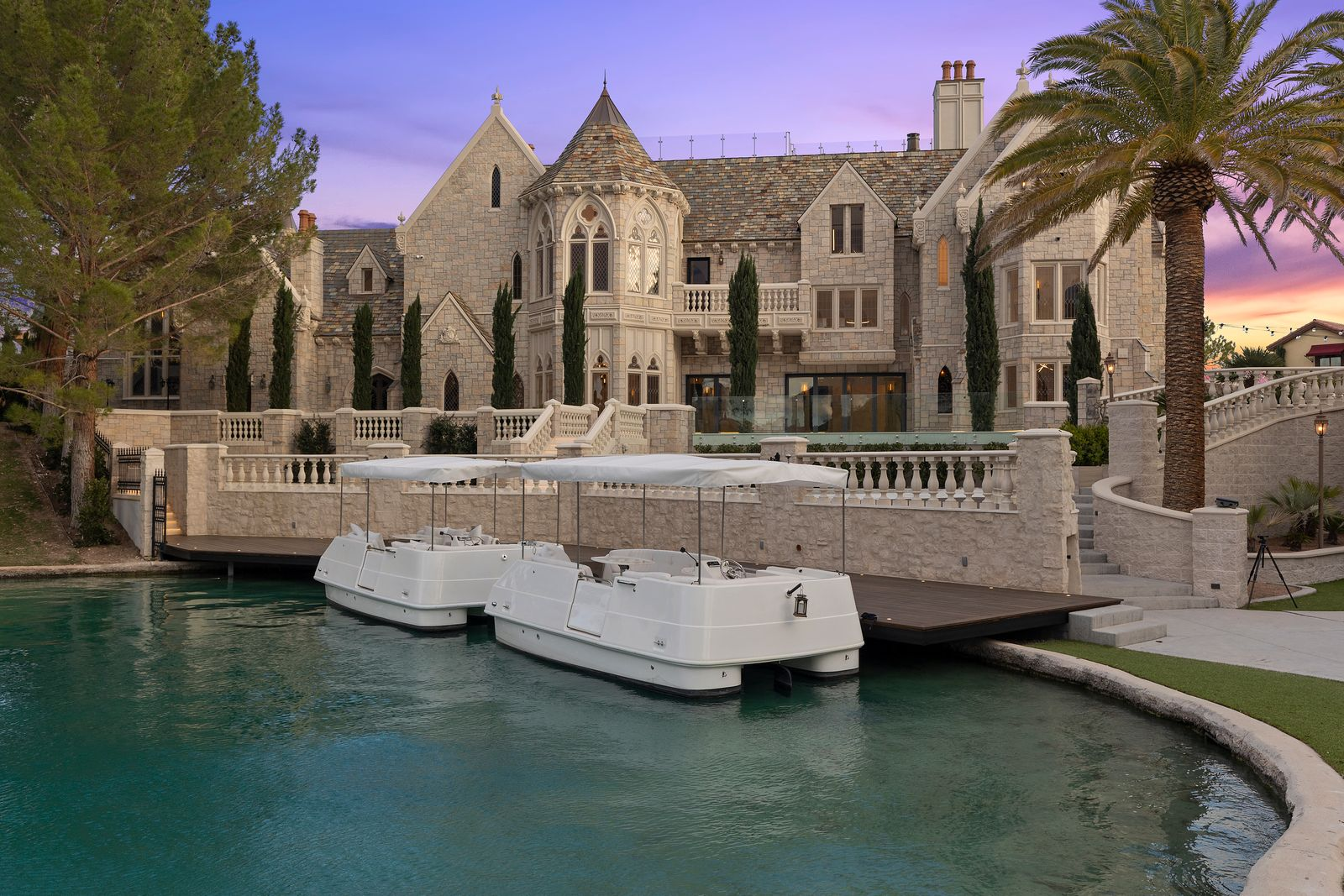 At the base of the property, a long private dock runs along the canal, creating a direct connection to the water.