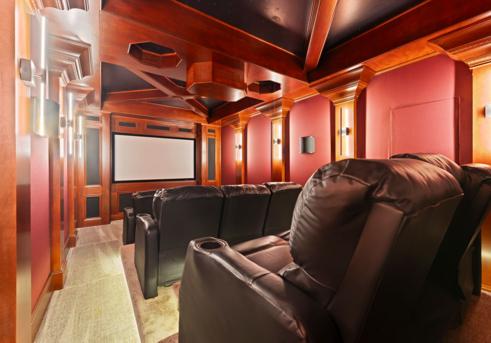 The home theater completes the level with leather reclining seats, red wall panels, wood trim, and a dedicated screen.