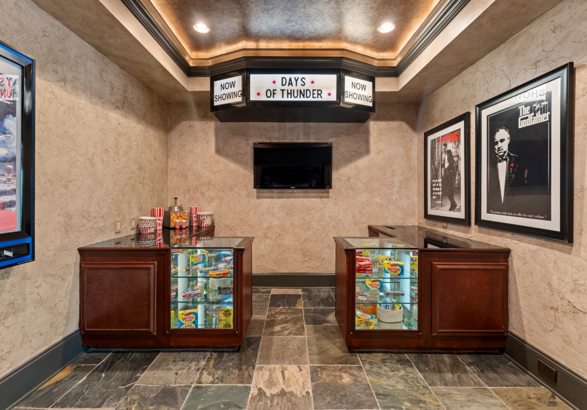 Just outside, a concession-style area with movie posters, display cases, and a “Days of Thunder” marquee adds a playful nod to Truex’s racing world.