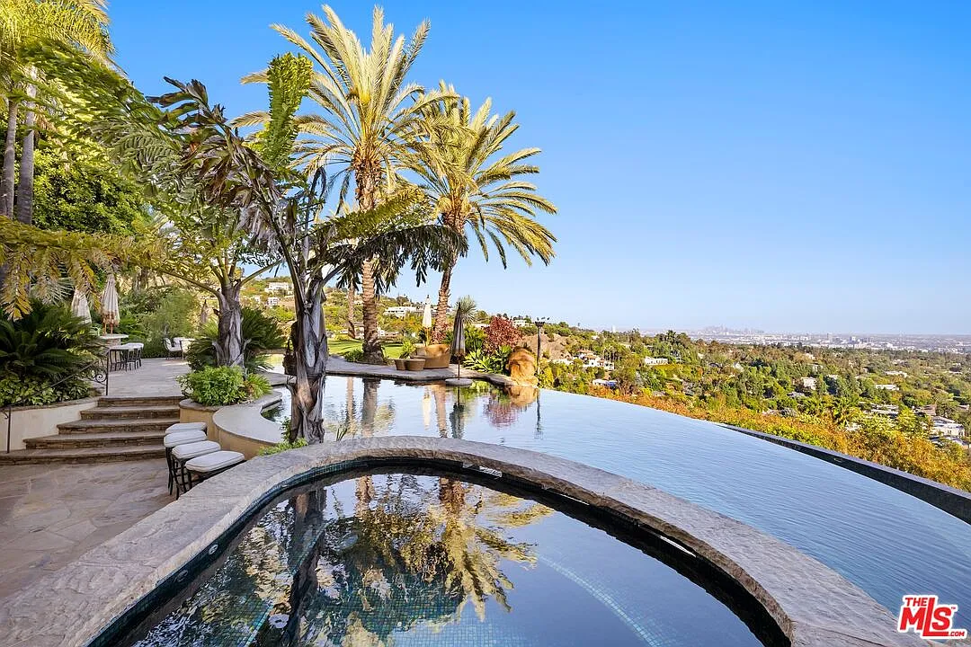 The pool then transitions into a lazy river, which passes a 35-foot waterslide and leads to a swim-up bar, where barstools and small tables are built right into the pool, beside the hot tub.