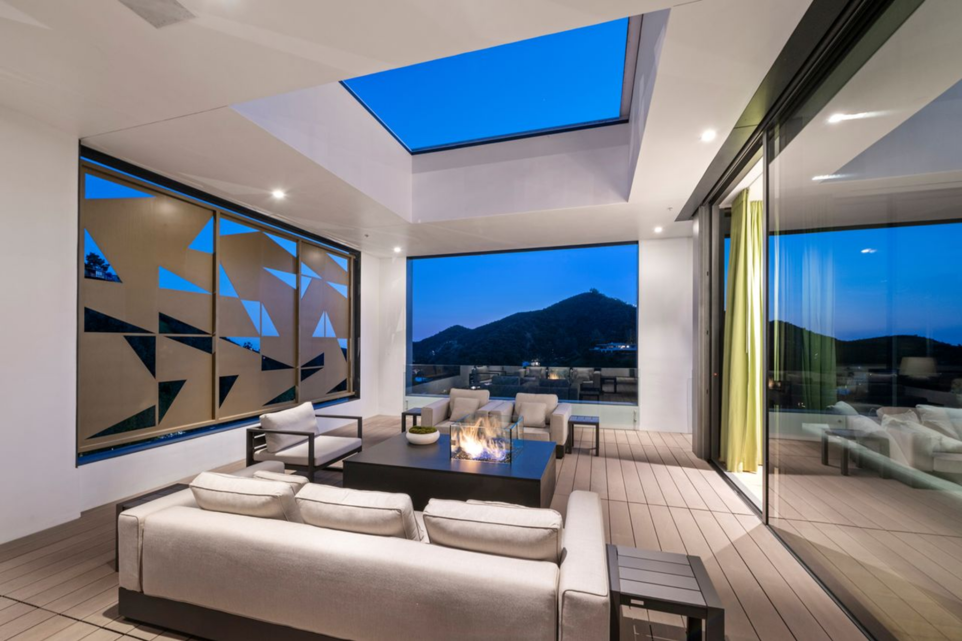 On the other side of the suite, the private patio functions as an open-air lounge beneath motorized skylights that open to bring in more light or allow for stargazing at night.