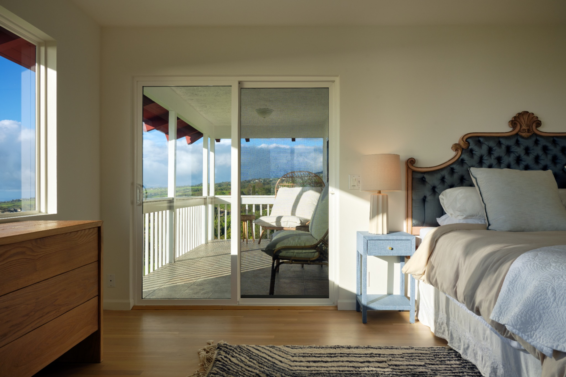 At the far side of the room, sliding glass doors open directly to a private covered balcony, which can also be accessed from the suite's bathroom.