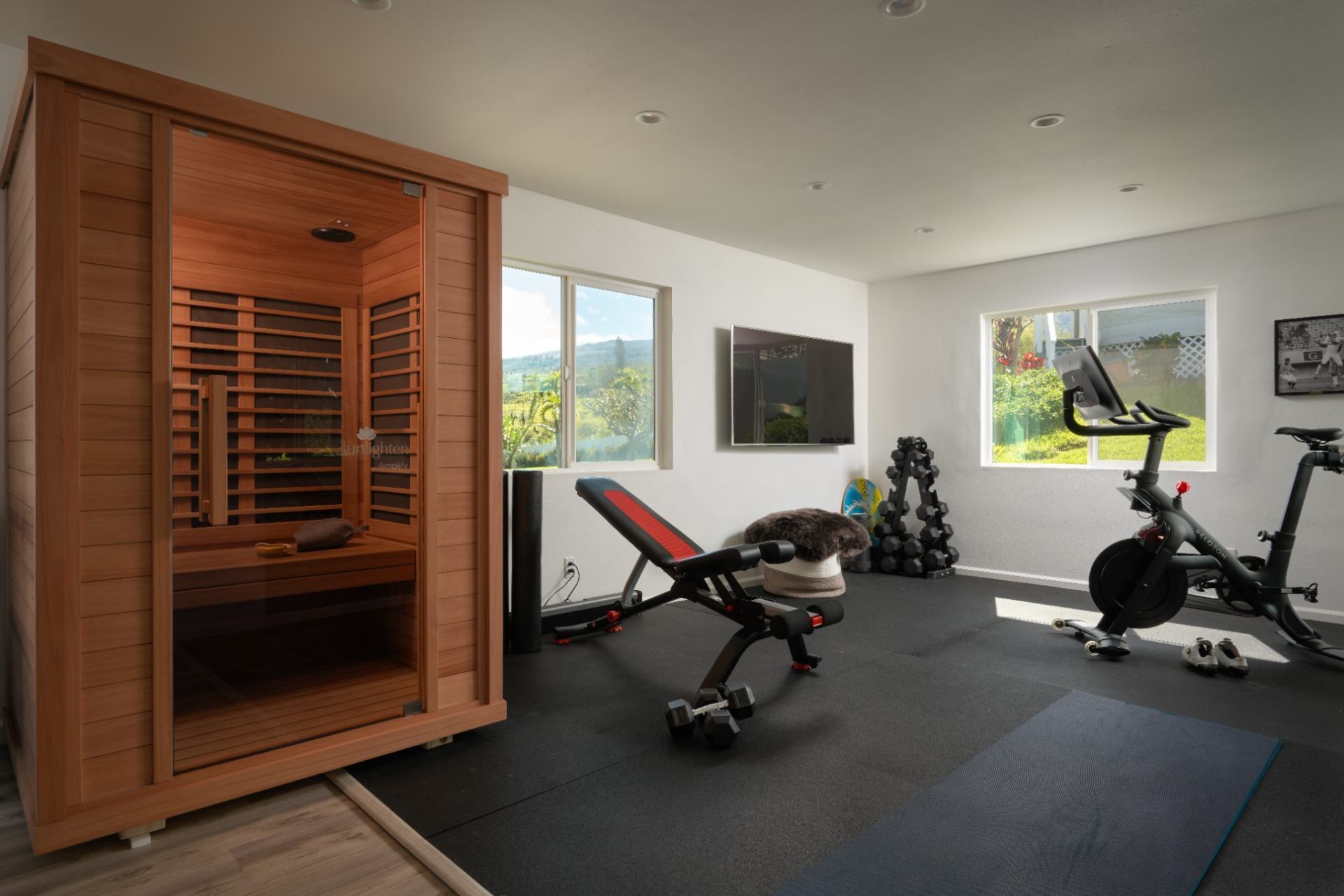 Also within the suite is a gym set up with rubber flooring, exercise equipment, an infrared sauna, and large windows that bring in natural light and views of the surrounding greenery. 