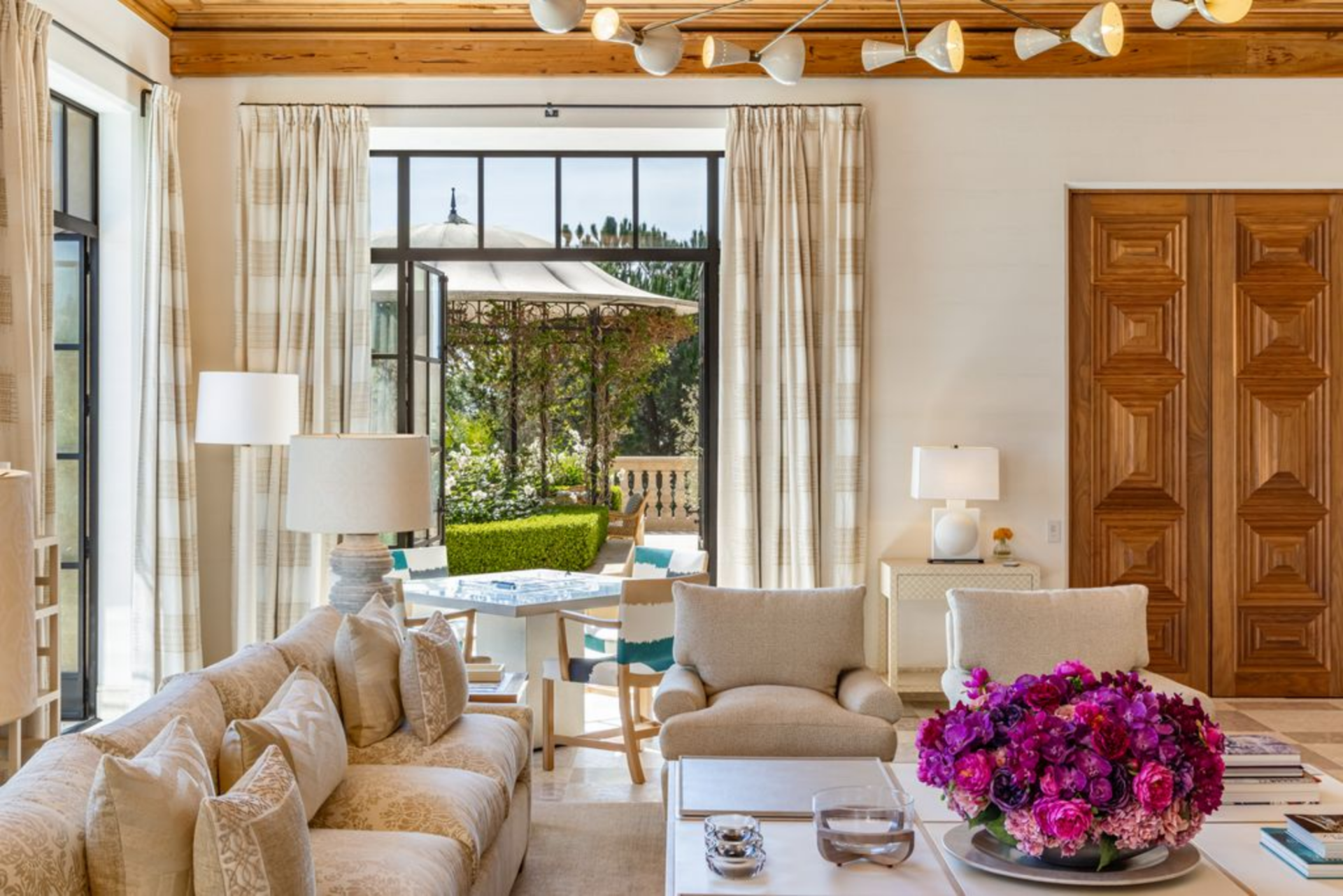 Not far away, a more relaxed lounge has direct access to a terrace through steel-framed glass doors. 