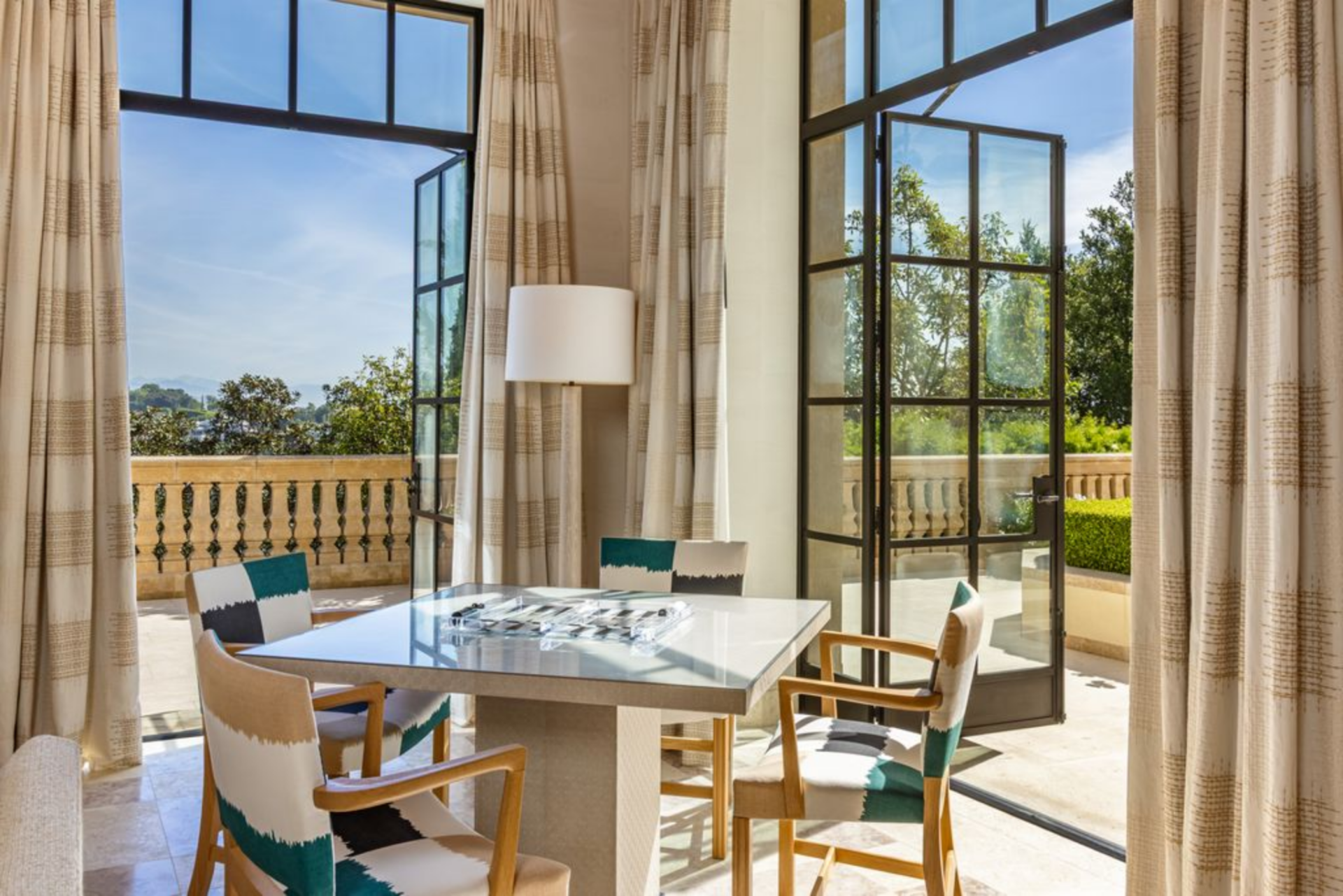 A compact table set near the windows creates a dedicated spot for games or casual gatherings.