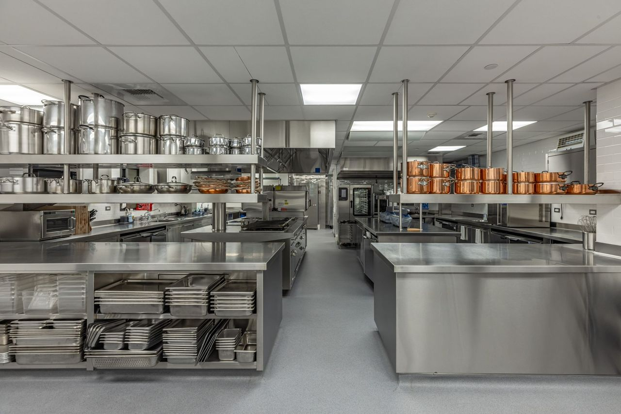 For more large-scale entertaining, the home has a commercial-grade kitchen with stainless-steel prep stations, open shelving, and rows of professional cookware. 