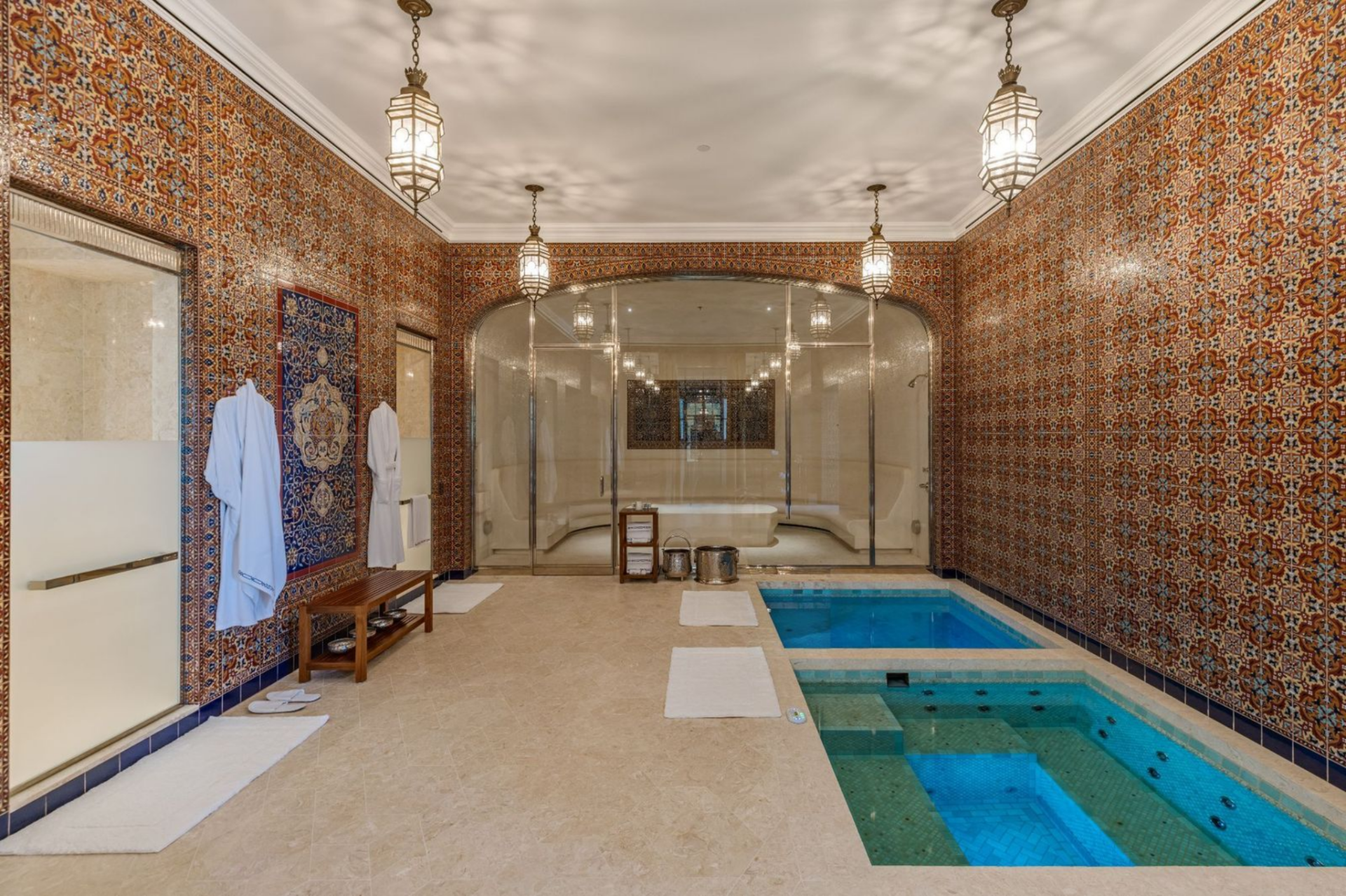 Nearby, the ice and hot plunge pools are set into the floor, creating a dedicated wellness zone alongside a sauna, and treatment rooms.