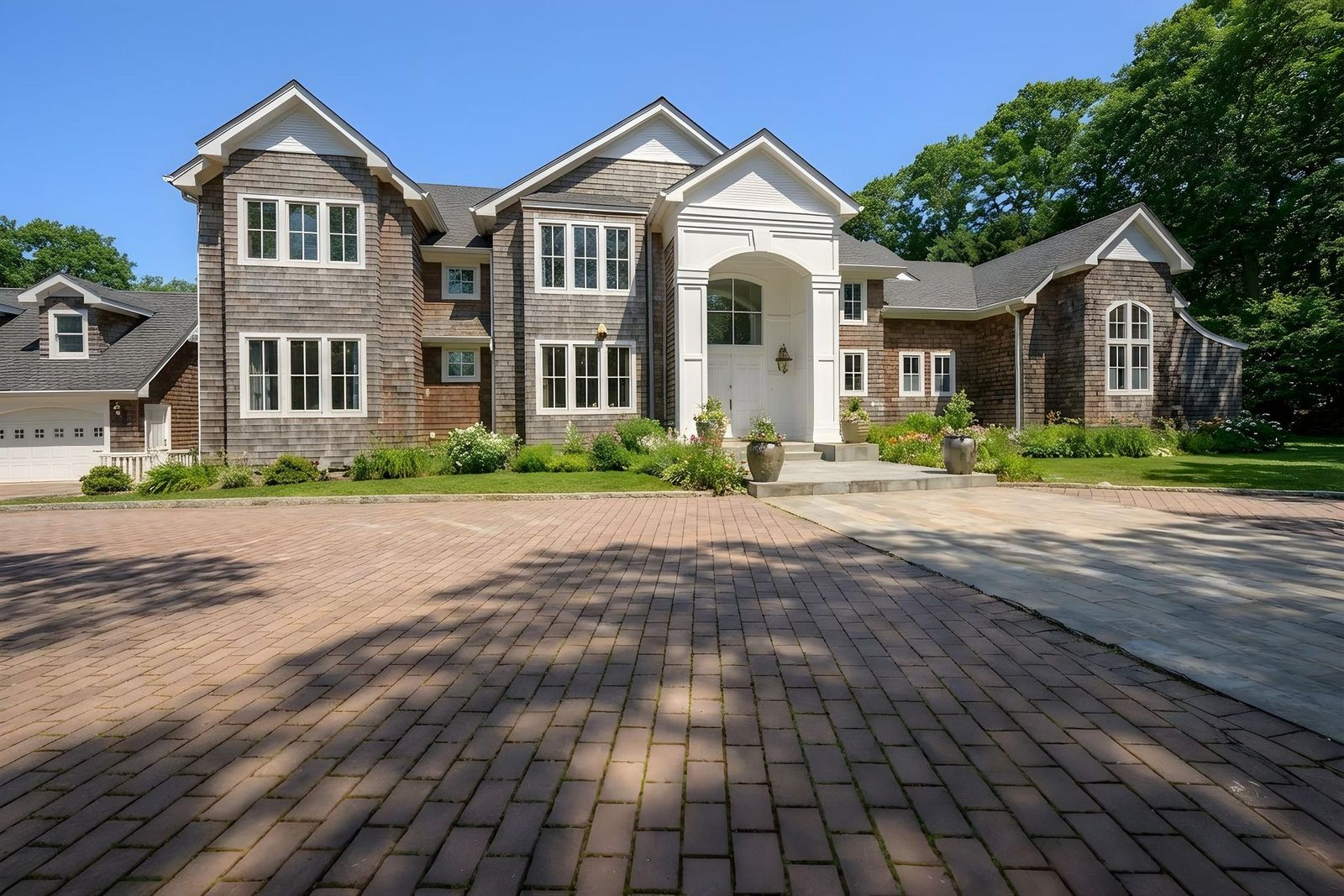 Bravo's "Summer House" mansion opens up at the end of a long brick driveway.