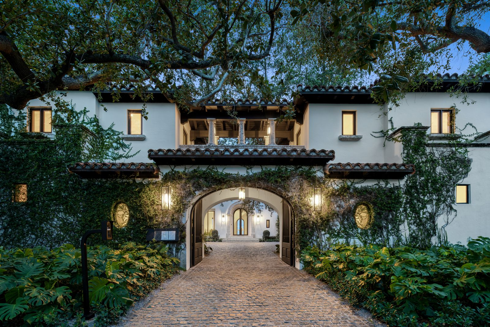 Front exterior of Miami house covered in climbing vines.