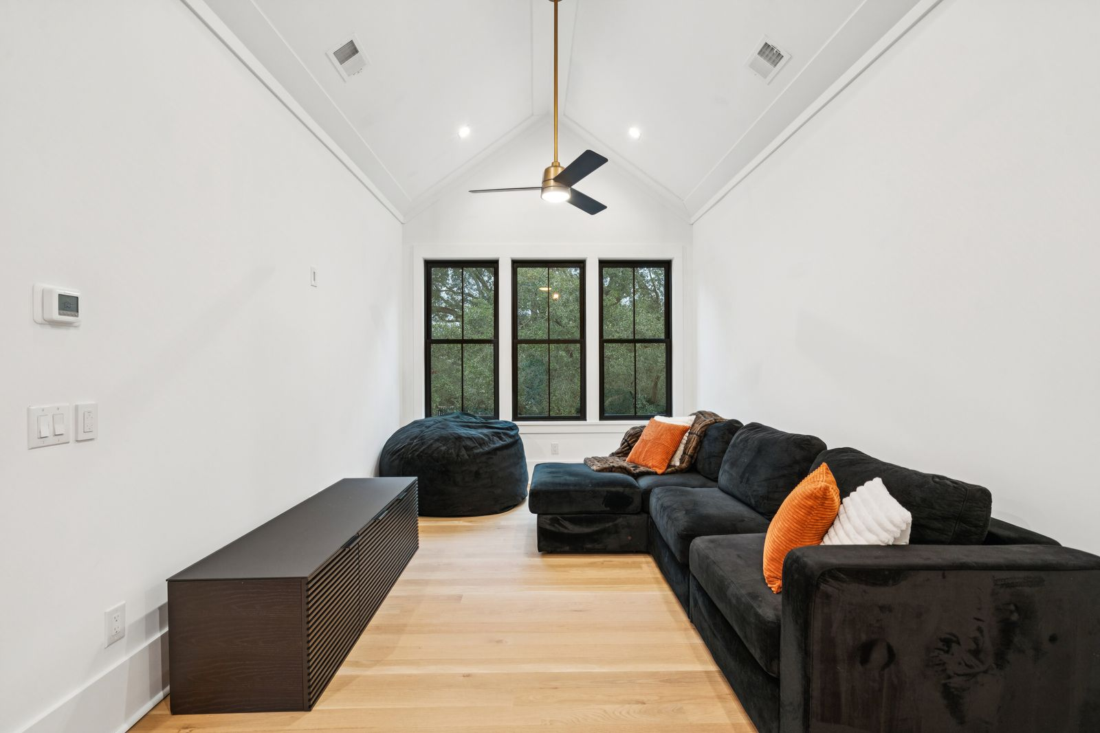 A relaxed media lounge with oversized sectional seating and beanbags