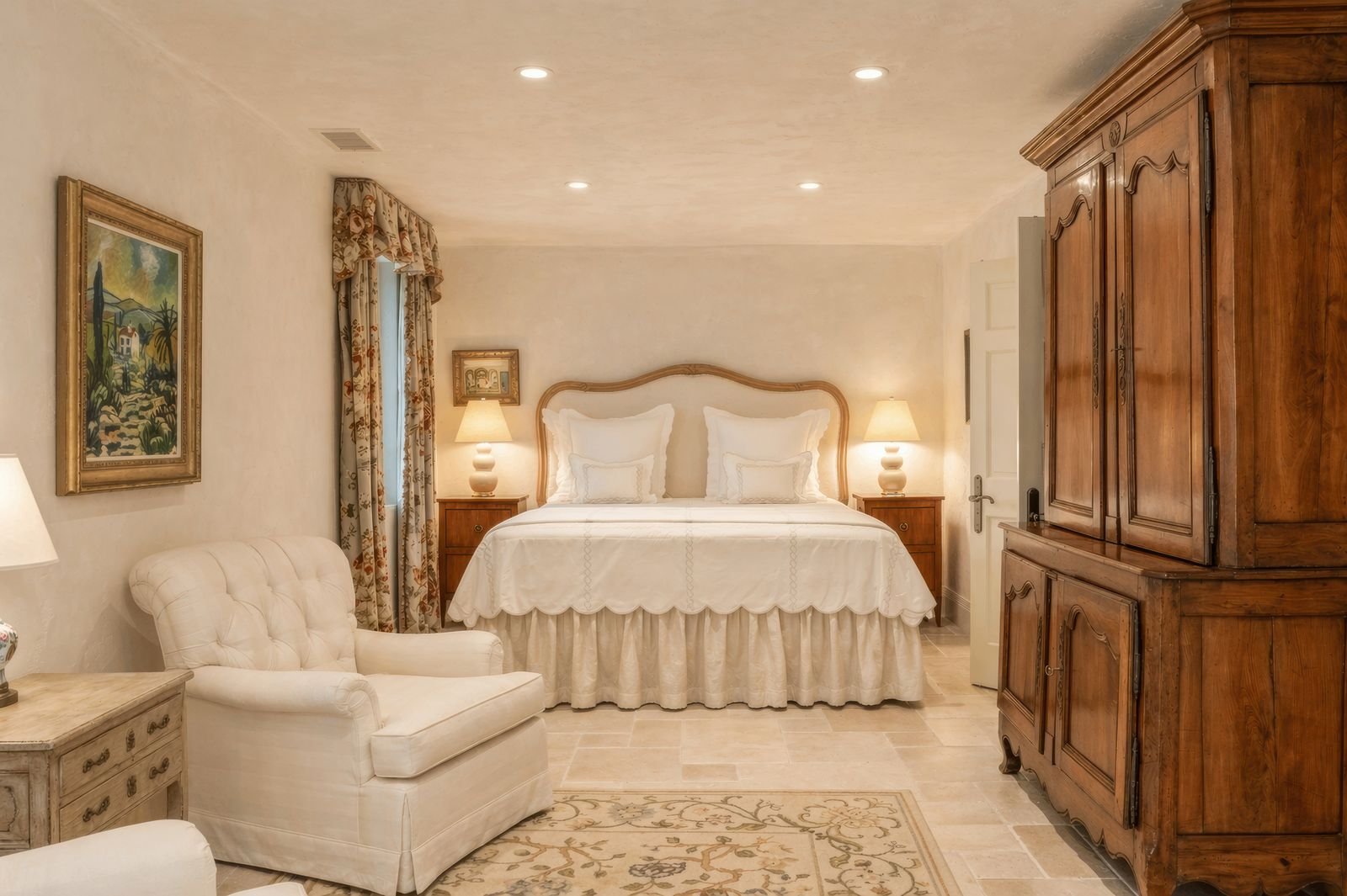 Another guest bedroom takes on a slightly more understated approach, centered around warm neutral tones and traditional furniture pieces.