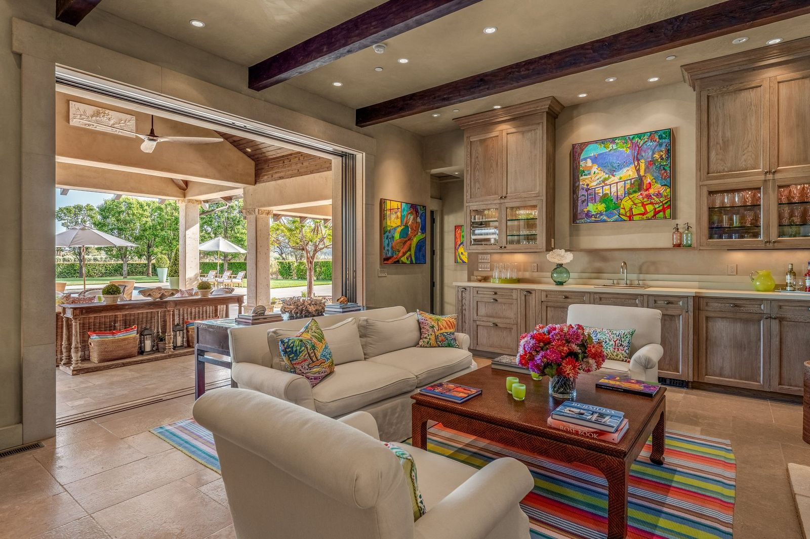 Inside, the space includes a sitting area, a built-in bar, and casual gathering spaces.